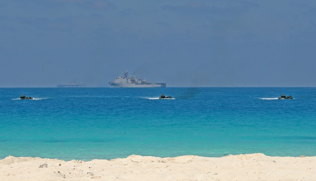 Three amphibious assault vehicles from Battalion Landing Team, 3rd Battalion, 2nd Marine Regiment, 22nd Marine Expeditionary Unit (MEU) launched from amphibious dock landing ship USS Fort McHenry (LSD 43), prepare to storm the beach during an amphibious assault demonstration conducted as part of Bright Star 2009 in Egypt Oct. 12, 2009. The multinational exercise is designed to improve readiness, interoperability, strengthen the military and professional relationships among U.S., Egyptian and participating forces. Bright Star is conducted by U.S. Central Command and held every two years. Elements of the 22nd MEU are currently are participating in the multi-national exercise while serving as the theater reserve force for U.S. Central Command.::r::::n::(Official Marine Corps Photo by Cpl. Theodore W. Ritchie)::r::::n::