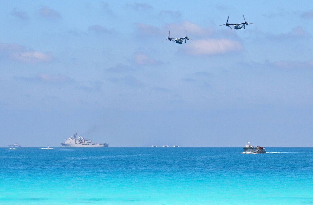 Two MV-22B Ospreys from Marine Medium Tiltrotor Squadron (VMM) 263 (Reinforced) attached to the 22nd Marine Expeditionary Unit (MEU), fly over landing craft during an amphibious assault demonstration conducted as part of Bright Star 2009 in Egypt Oct. 12, 2009. The multinational exercise is designed to improve readiness, interoperability, strengthen the military and professional relationships among U.S., Egyptian and participating forces. Bright Star is conducted by U.S. Central Command and held every two years. Elements of the 22nd MEU are currently are participating in the multi-national exercise while serving as the theater reserve force for U.S. Central Command.::r::::n::(Official Marine Corps Photo by Cpl. Theodore W. Ritchie)