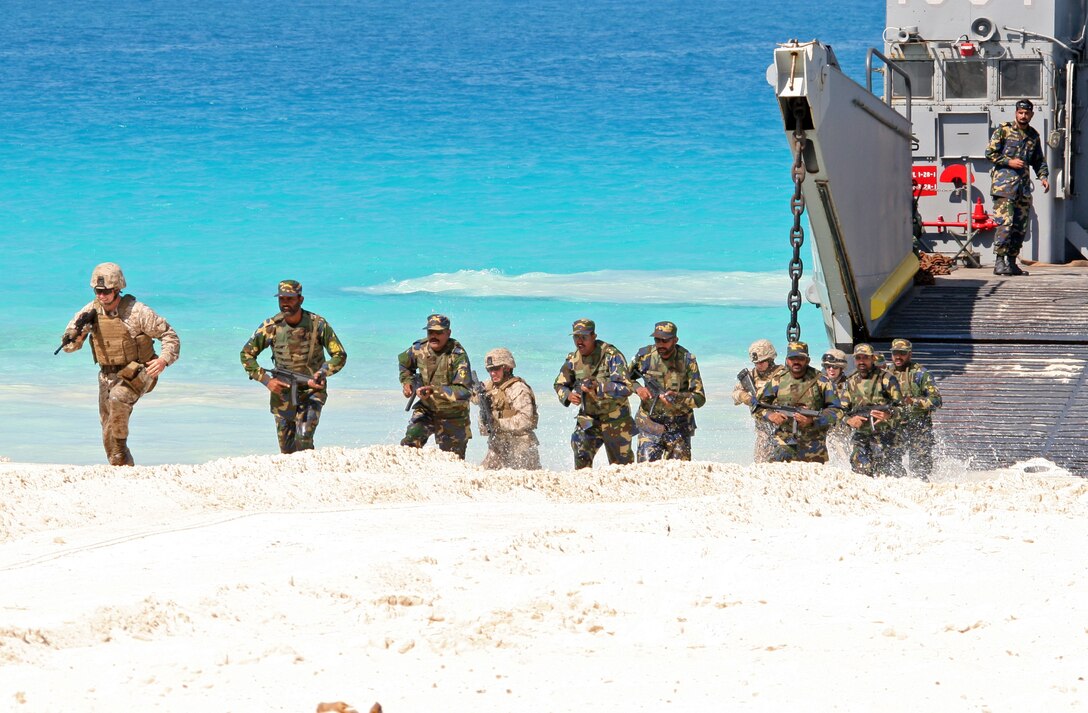 Marines from the 22nd Marine Expeditionary Unit (MEU), along with Pakistani Marines, storm ashore from a landing craft utility (LCU) from Assault Craft Unit (ACU) 2 during an amphibious assault demonstration conducted as part of Bright Star 2009 in Egypt Oct. 12, 2009. The multinational exercise is designed to improve readiness, interoperability, strengthen the military and professional relationships among U.S., Egyptian and participating forces. Bright Star is conducted by U.S. Central Command and held every two years. Elements of the 22nd MEU are currently are participating in the multi-national exercise while serving as the theater reserve force for U.S. Central Command.::r::::n::(Official Marine Corps Photo by Cpl. Theodore W. Ritchie)::r::::n::