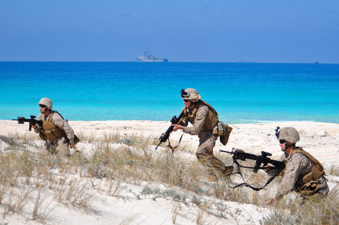 Marines from the 22nd Marine Expeditionary Unit (MEU) tactically position themselves during an amphibious assault demonstration near Alexandria, Egypt, in support of exercise Bright Star 2009. The multinational exercise is designed to improve readiness, interoperability, and strengthen military and professional relationships among U.S., Egyptian and several other participating forces. Bright Star is conducted by U.S. Central Command and held every two years (U.S. Navy photo by Mass Communication Specialist 2nd Class (SW) Stephen Oleksiak/RELEASED)