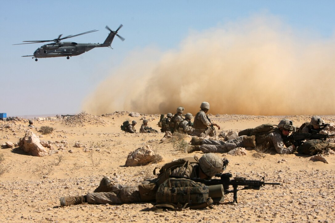 Marines with Lima Company, Battalion Landing Team, 3rd Battalion, 2nd Marine Regiment, 22nd Marine Expeditionary Unit, set up security in Egypt as a CH-53E Super Stallion with Marine Medium Tiltrotor Squadron 263 (Reinforced), 22nd MEU, takes off during Exercise Bright Star 2009 in Egypt, Oct. 12, 2009. The multinational exercise is designed to improve readiness, interoperability, and strengthen the military and professional relationships among U.S., Egyptian and participating forces. Bright Star is conducted by U.S. Central Command and held every two years. Elements of the 22nd MEU are currently are participating in the multi-national exercise while serving as the theater reserve force for U.S. Central Command.::r::::n::(Official Marine Corps Photo by Cpl. Justin M. Martinez)::r::::n::