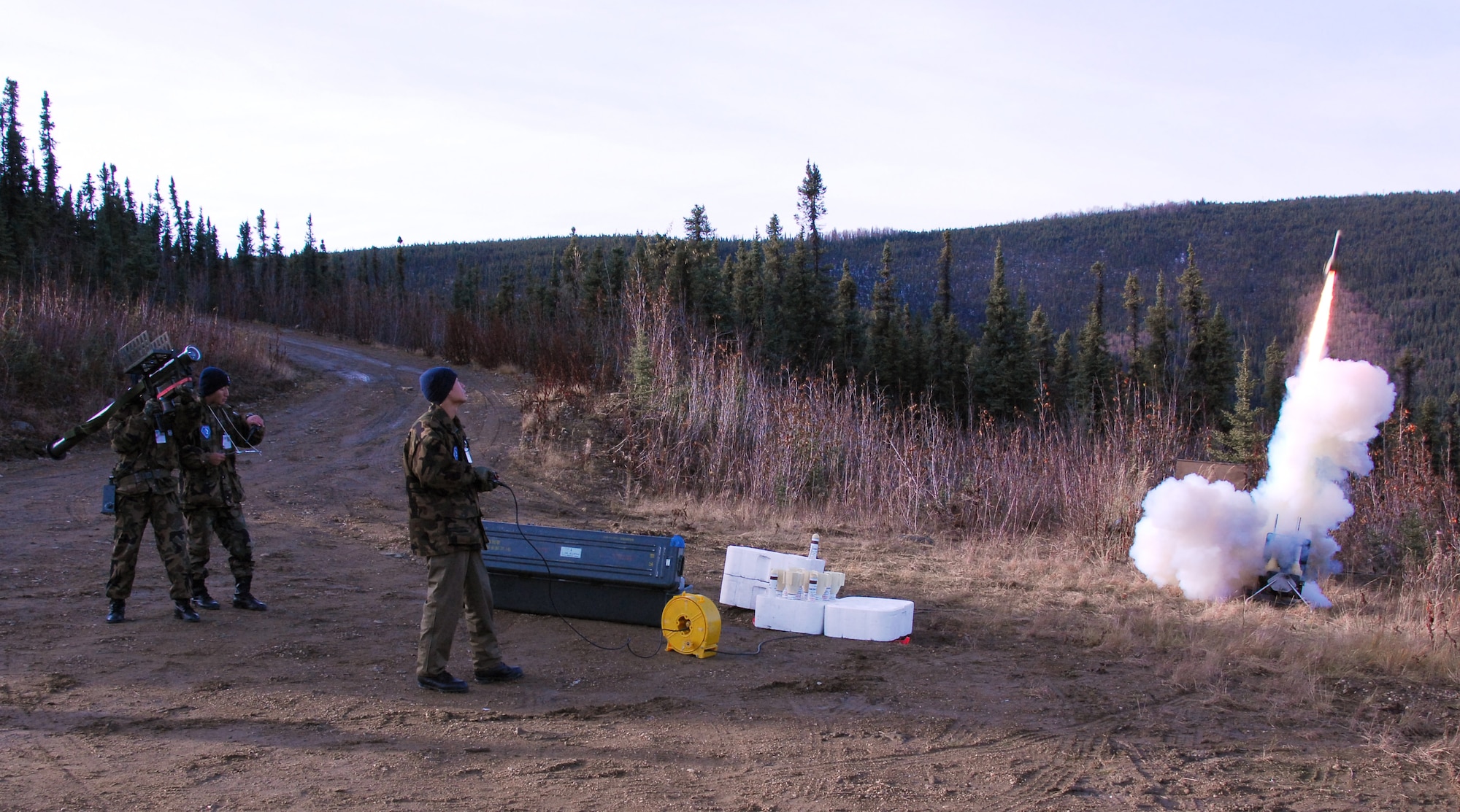 Staff Sergeants Shoji Yamamoto, gunner, Masami Ishida, team chief, and Kazuma Yamaji, Smokey Sam launcher, simulate launching an anti-aircraft rocket for training during RED FLAG-Alaska 10-1 Oct. 9, 2009, Eielson Air Force Base, Alaska. RF-A provides unique opportunities to integrate various forces into joint, coalition and bilateral training from a simulated forward operating base. They are Japan Air Self Defense Force airmen assigned to Naha Air Base, Okinawa, Japan. (U.S. Air Force photo/Tech. Sgt. Shad Eidson)
