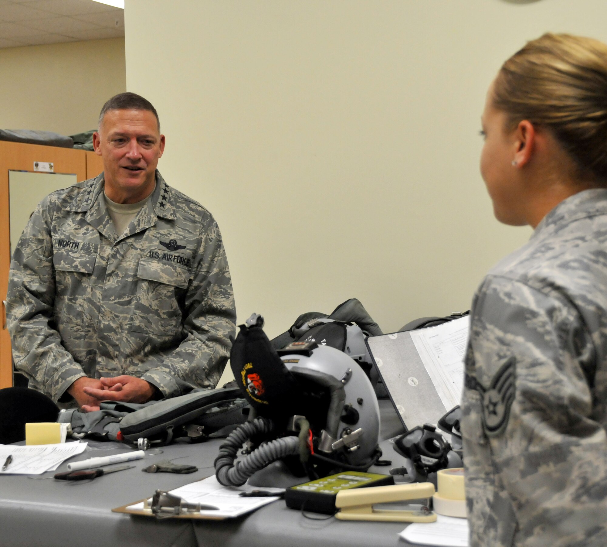 Gen. Gary North, U.S. Pacific Forces commander, discusses the life support mission with Staff Sgt. Kim Gage, 80th Fighter Squadron aircrew flight equipment journeyman, at Kunsan Air Base, Republic of Korea, during a visit here Oct. 5, 2009. Throughout the three-day visit, the general toured base facilities, hosted an Airman's Call and met with Airmen to talk about their role in the Air Force and PACAF mission. (U.S. Air Force photo/Capt. Shannon Collins)