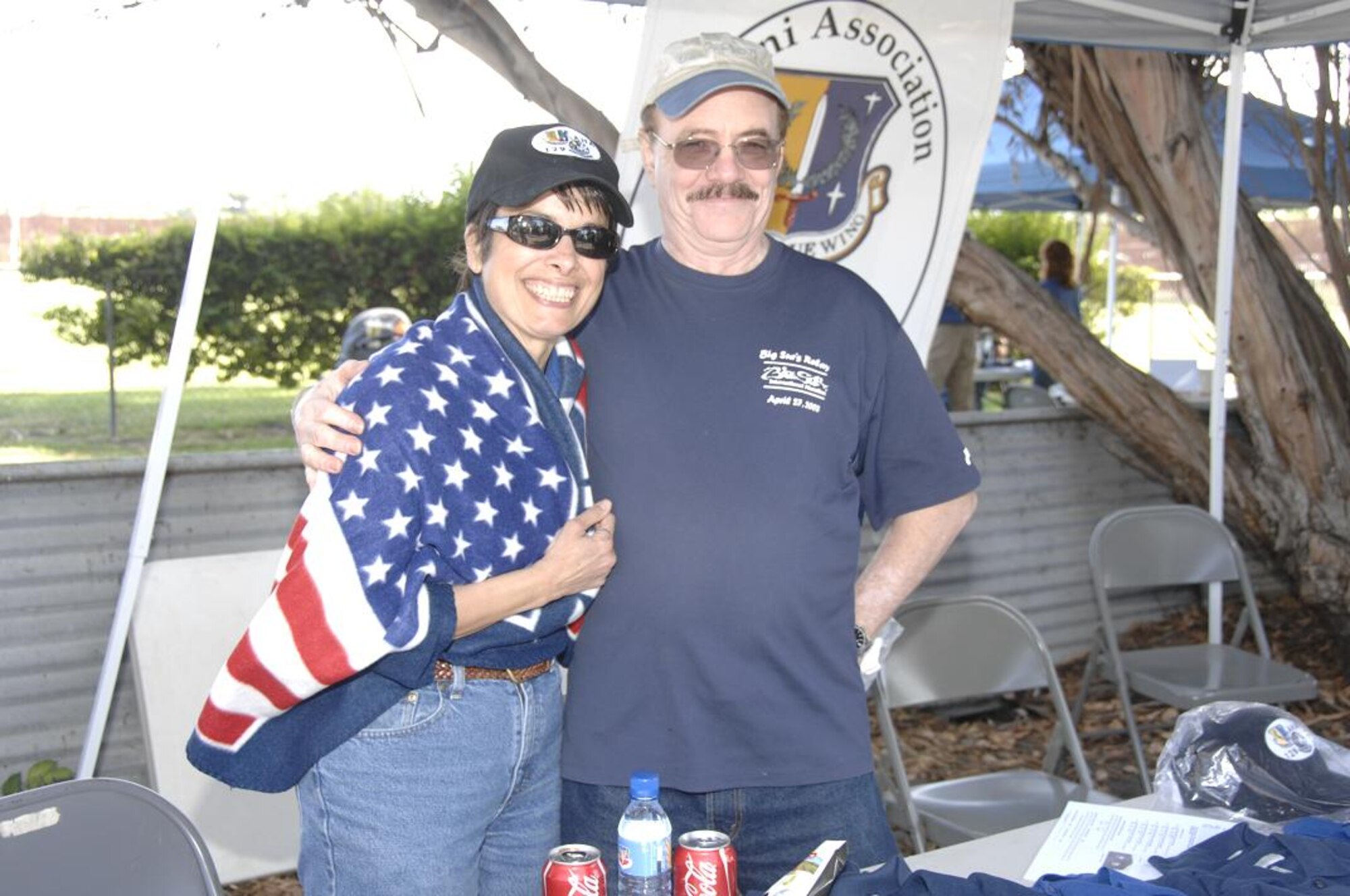 Retired 129th Rescue Wing Command Chief Master Sgt. Liliana Ramos and husband Domingo Ramos, snuggle up under the 129th RQW’s Alumni Association hospitality tent Oct. 3 at the annual Family Day Picnic hosted Oct. 4 at Moffett Federal Airfield, Calif. (Air National Guard photo by Master Sgt. Dan Kacir)
