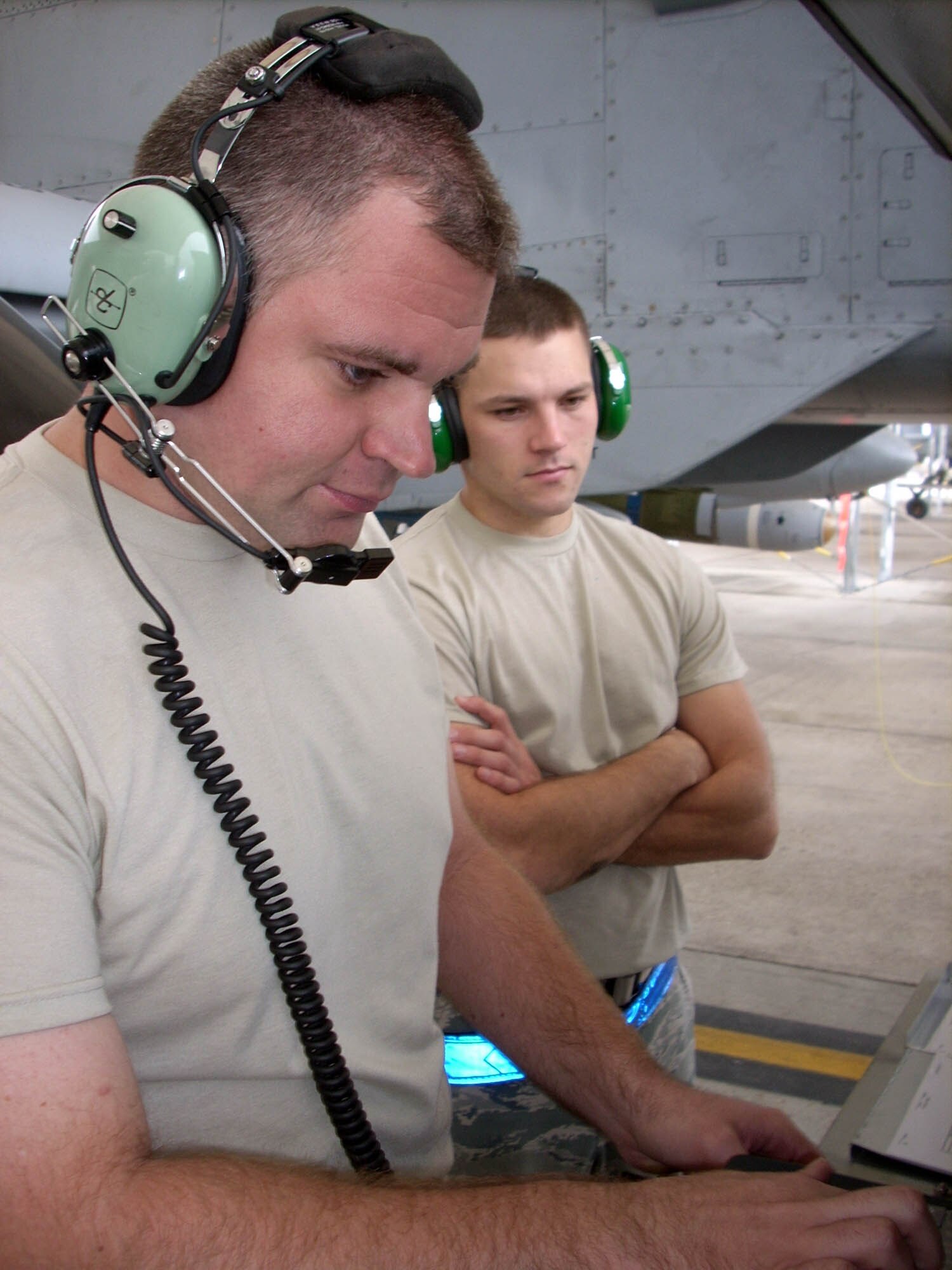 Staff Sgt. Scott Miller (left), COMBAT SHIELD technician, is observed by Staff Sgt. Samuel Sargent while conducting his first assessment with a USM-642 "Raven" test set at Moody Air Force Base, Ga. The COMBAT SHIELD program serves to simulate enemy radar attacks by injecting radio frequency power into the antennas and receivers of fighter jets in order to test their responses. Sergeant Miller is a reservist with the 84th Test and Evaluation Squadron at Eglin Air Force Base, Fla., integrated into the Regular Air Force's 53rd Electronic Warfare Group at Eglin. The Total Force Integration team travels to fighter units across the world to test their aircrafts' readiness.
