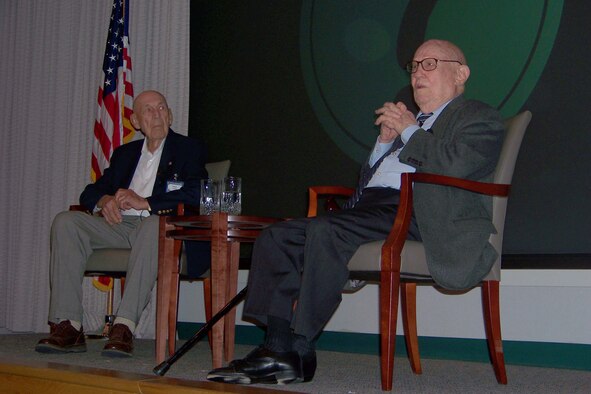 Retired Col. Richard Cole, left, and retired Maj. Gen. John Alison speak to audience members during the Air Commando Heritage Symposium at the Air Force Special Operations Training Center auditorium at Hurlburt Field Oct. 9. (U.S. Air Force photo by Airman 1st Class Joe McFadden.) 
