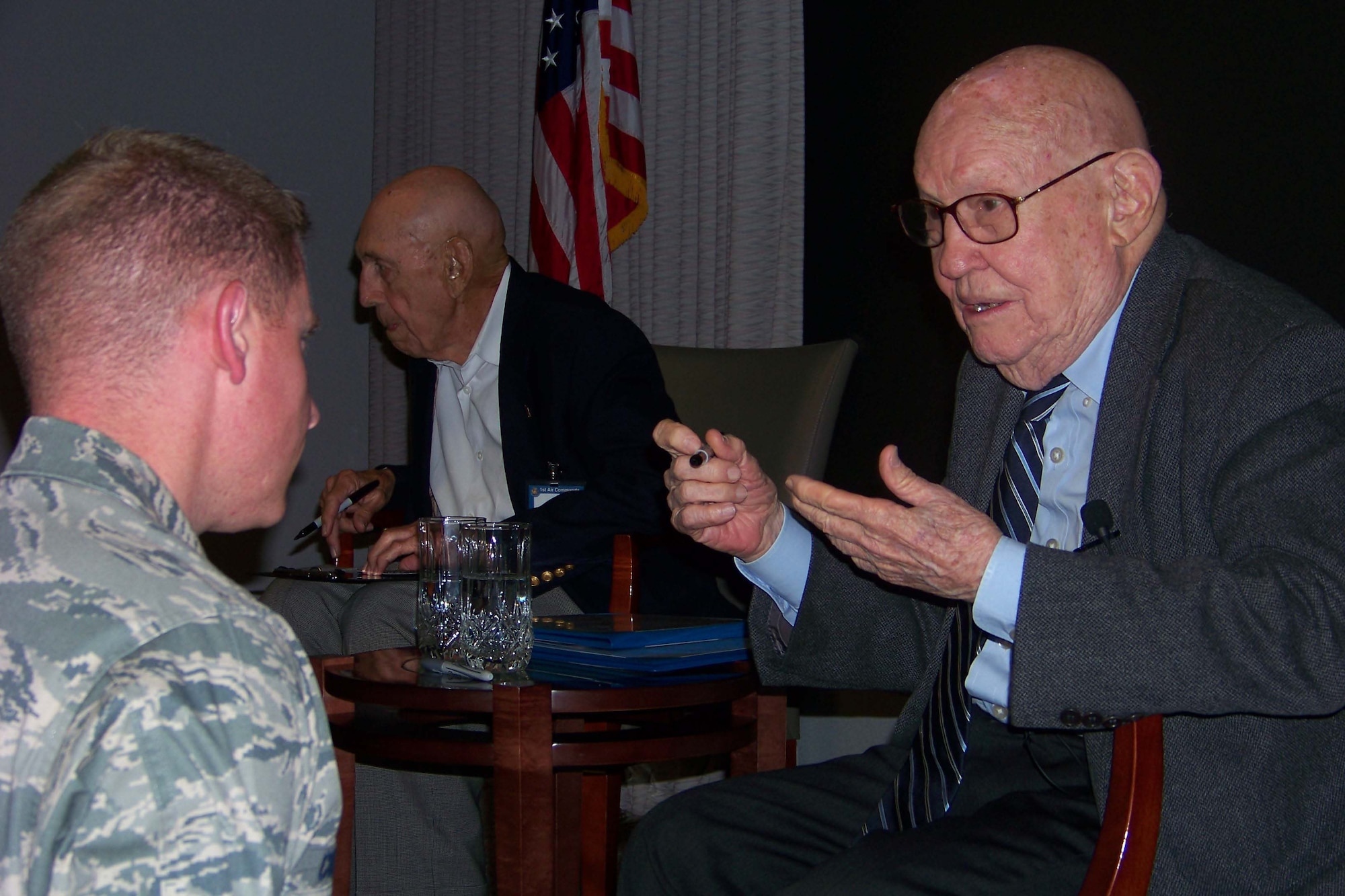 Retired Maj. Gen. John Elison, right, speaks with an airman during the Air Commando Heritage Symposium at the Air Force Special Operations Training Center auditorium at Hurlburt Field Oct. 9. (U.S. Air Force photo by Airman 1st Class Joe McFadden.)