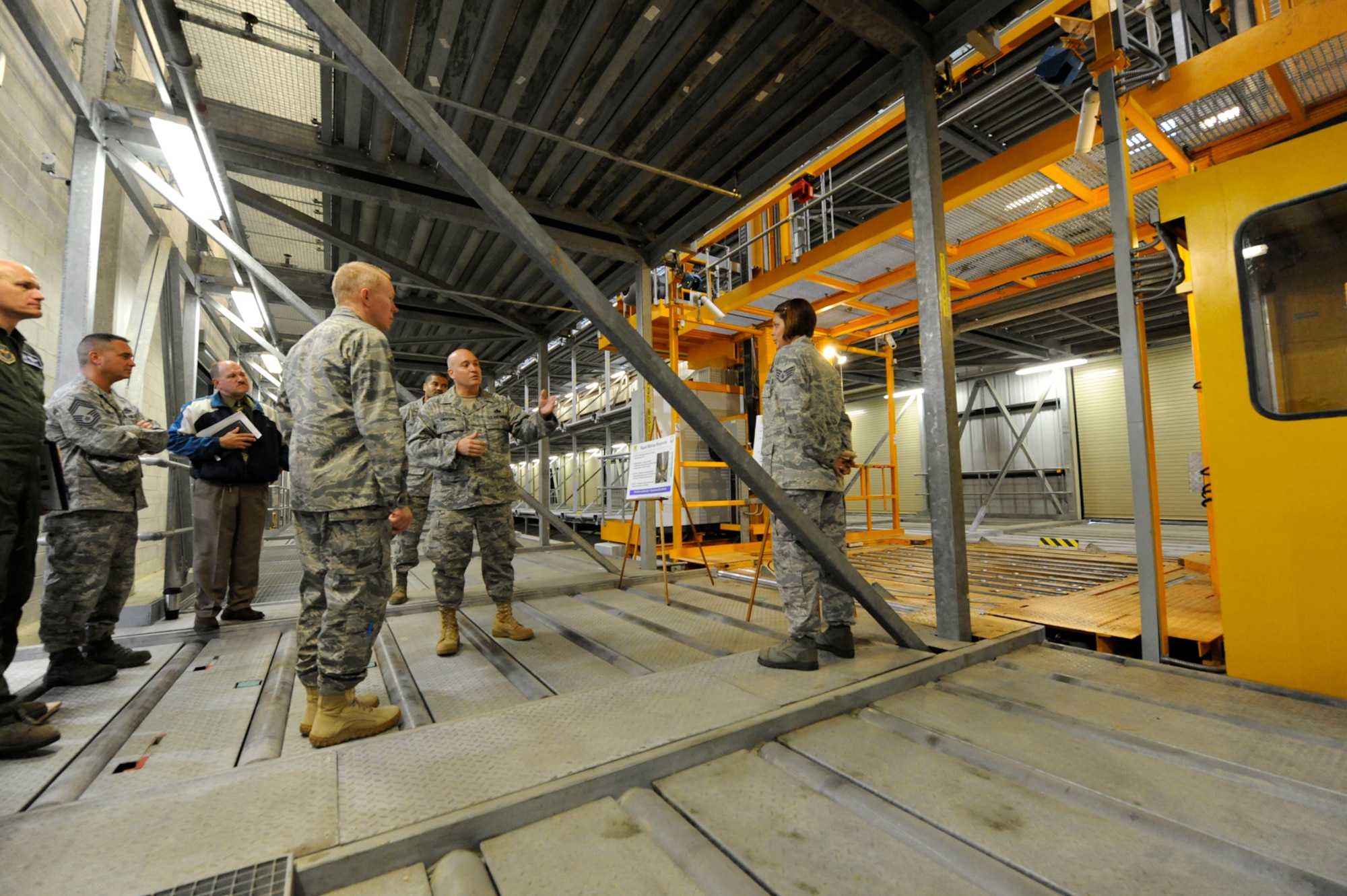 (Center) Senior Master Sgt. Edward Swinson, 436th Aerial Port Squadron, briefs Col. Steven Jordan, Air Mobility Command Installation Excellence Selection Board team member, about the aerial port response to the Elevated Transfer Vehicle mishap during the Installation Excellence visit Oct. 7. When the ETV mishap occurred, experienced aerial porters immediately began designing a pallet grid to ensure that the flow of cargo to the warfighter was uninterrupted. (U.S. Air Force photo by Jason Minto)