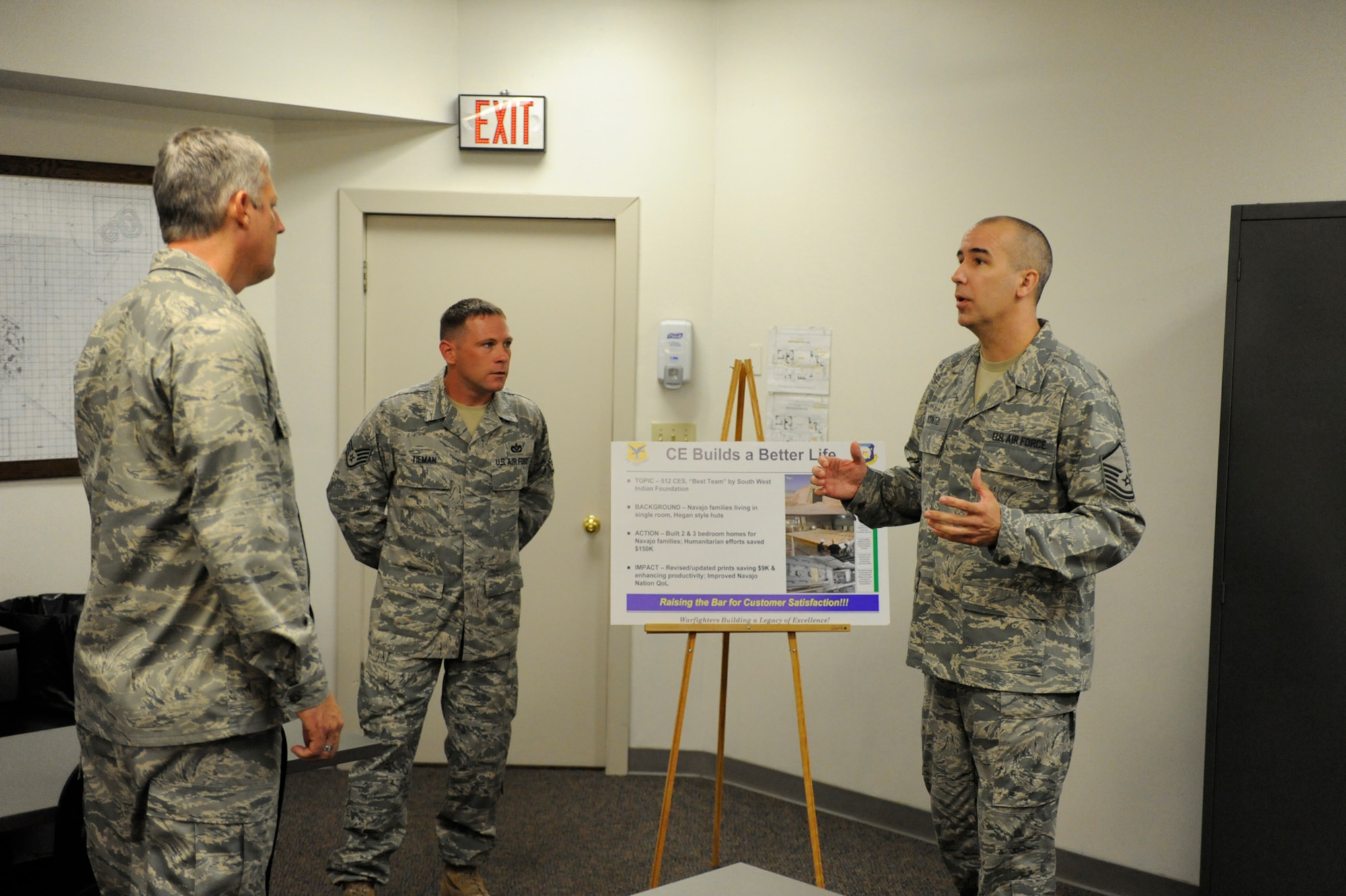 (From right) Master Sgt. David Kuntzi, 512th Civil Engineer Squadron, and Staff Sgt. Jacob Tieman, 512th CES, brief Col. Richard Stonestreet, Air Mobility Command Installation Excellence Selection Board team leader, about humanitarian construction efforts the civil engineers assisted. (U.S. Air Force photo by John Sidoriak)