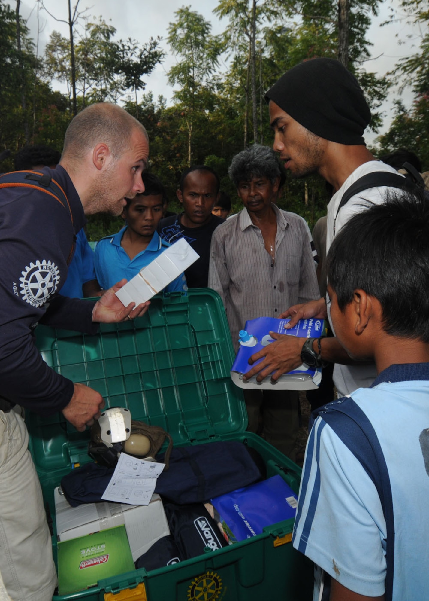 Shane Ravill (left), a ShelterBox Trust volunteer, gives an Indonesian villager a demonstration on using water purification tablets Oct. 11. ShelterBox Trust, an international disaster relief charity that delivers emergency shelters to people affected by disasters, donated emergency relief boxes following earthquakes that struck Indonesia Sept. 30. Each box contains a ten person tent, multi-fuel stove, blankets, water purification tablets, basic tools and cookware among others. The U.S. military, including a 71-member Air Force Humanitarian Assistance Rapid Response Team, is also in Indonesia assisting in relief operations throughout Indonesia. (U.S. Air Force photo/ Staff Sgt. Veronica Pierce)