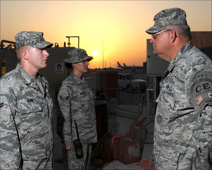 Airmen 1st Class Brandon Horn, left, and Christina Bennett, center, 379th Expeditionary Civil Engineer Squadron force protection and security escorts, provide a post brief to Senior Master Sgt. Roger Kuhlmann, 379th ECES escort flight chief. Sergeant Kuhlmann is deployed from Vance Air Force Base, Okla., where he serves as the 71st Force Support Squadron superintendent. He is supporting Operations Iraqi Freedom and Enduring Freedom. (U.S. Air Force photo/ Tech. Sgt. Jason W. Edwards)
