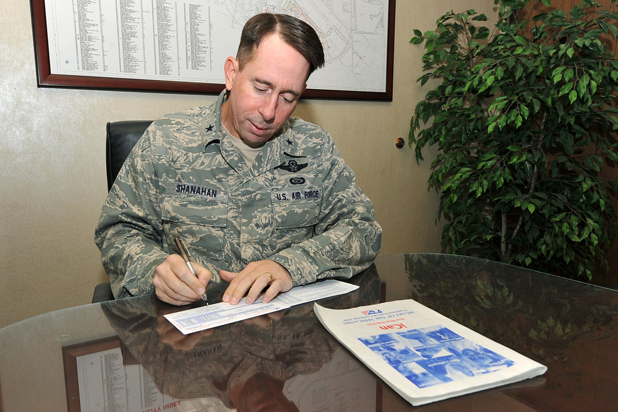 OFFUTT AIR FORCE BASE, Neb. -- Brig. Gen. John N.T. Shanahan, 55th Wing commander, completes a Combined Federal Campaign donation form here Sept. 29. With his donation, General Shanahan started Team Offutt on its goal of $325,000.00 in CFC contributions. As of Oct. 13, Offutt has raised $96,884.00. Pledges made to the CFC support eligible non-profit organizations that provide health and human service benefits throughout the world. U.S. Air Force Photo by Charles Haymond