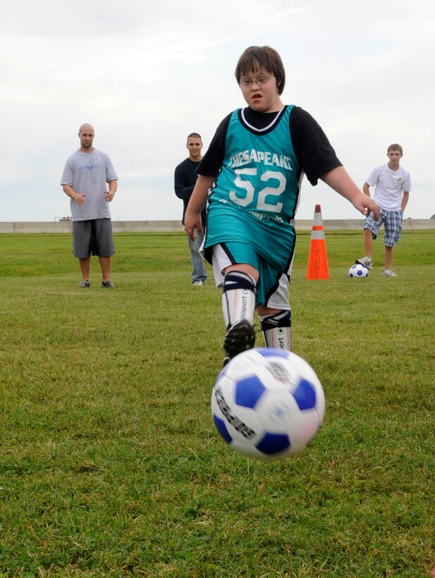 LANGLEY AIR FORCE BASE, Va. - Hunter McGrath, a member of the Chesapeake Dolphins, pushes his way down the field during the Special Olympics here Oct. 10.   Approximately 200 athletes put their talents on display during this annual event by participating in the special skill challenges offered by Col. Matt Molloy, 1st Fighter Wing commander and many Langley volunteers. (U.S. Air Force photo/Senior Airman Dana Hill)