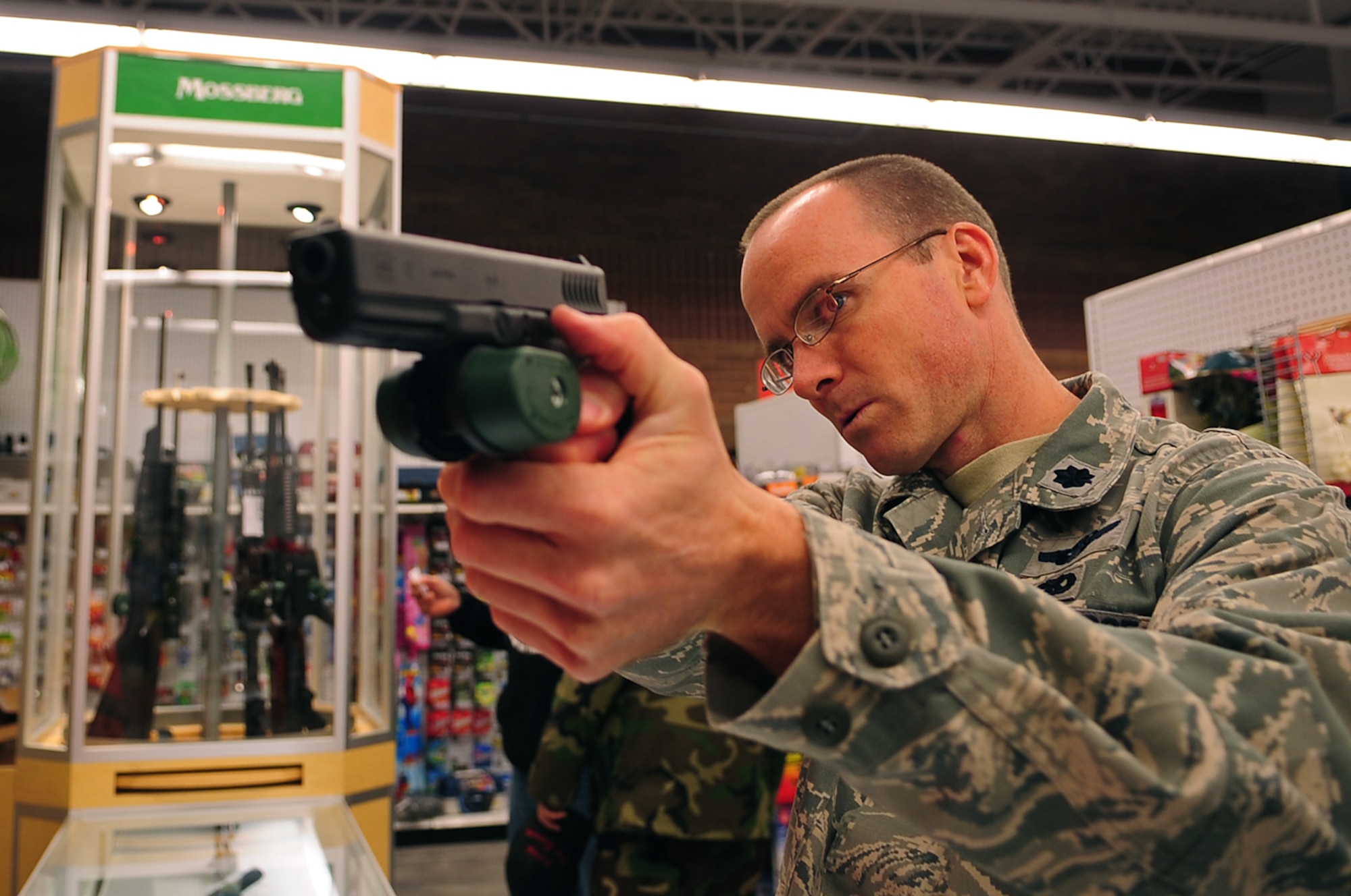 Whiteman AFB, Mo.- Lt. Col. Matthew Snyder, 509th Maintenance Operation Squadron commander, inspects a handgun at the Base Exchange. The firearms and ammunition section opened Oct. 6 as an additional segment of the Whiteman BX.  (U.S. Air Force photo/Senior Airman Jessica Snow)