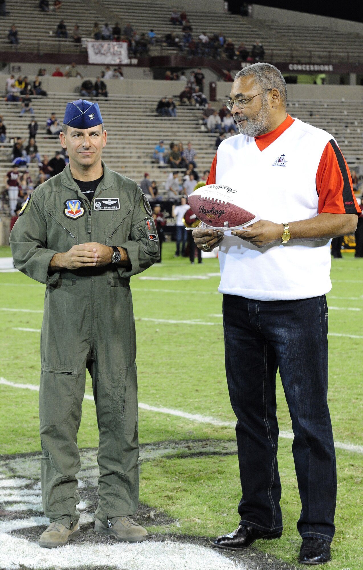 LAS CRUSES, N.M. -- Col. Jeff Harrigian, 49th Fighter Wing commander,
prepares to receive a football from Dr. McKinley Boston, athletic director
of New Mexico State University, as a gesture of military appreciation. Dr.
Boston gave the ball to Colonel Harrigian to recognize him and other
military members for their continued support in making America safe. (U.S.
Air Force photo by Senior Airman Tiffany Trojca)