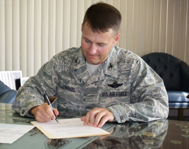 Col. Gregory Lengyel, 1st Special Operations Wing commander, signs a proclamation declaring October Energy Awareness Month. President George H.W. Bush officially established October as Energy Awareness Month in 1991. Hurlburt Field will be hosting a series of events throughout the month to highlight energy-saving initiatives. (Photo courtesy of Marc Barrett) 
