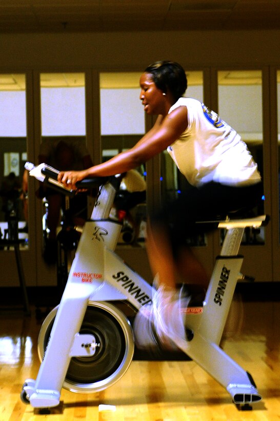 Senior Airman Tamiya Skinner, 28th Force Support Squadron fitness specialist, calls out the next exercise in a spin class at Bellamy Fitness Center here, September 15. The class is taught on a specially designed stationary cycle for an aerobic exercise. (U.S. Air Force photo/Senior Airman Kasey Zickmund)
