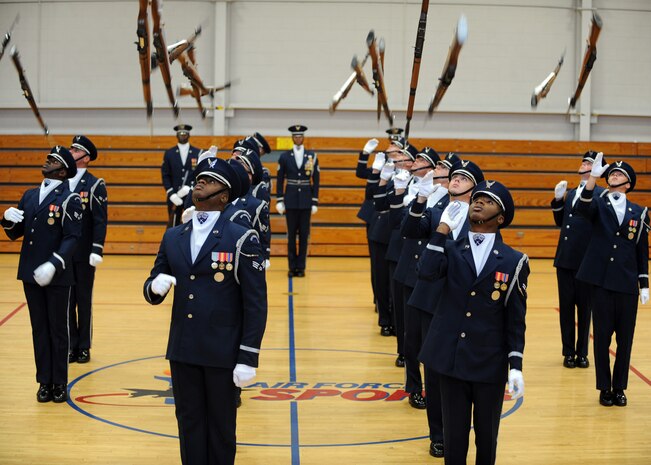 The Air Force Honor Guard Drill Team performs at the Fitness and Sports Center here Oct. 9. The performance featured a professionally choreographed sequence of show-stopping weapon maneuvers, precise tosses, complex weapon exchanges and a walk through the gauntlet of spinning weapons. (U.S. Air Force photo/Senior Airman Katie Gieratz)