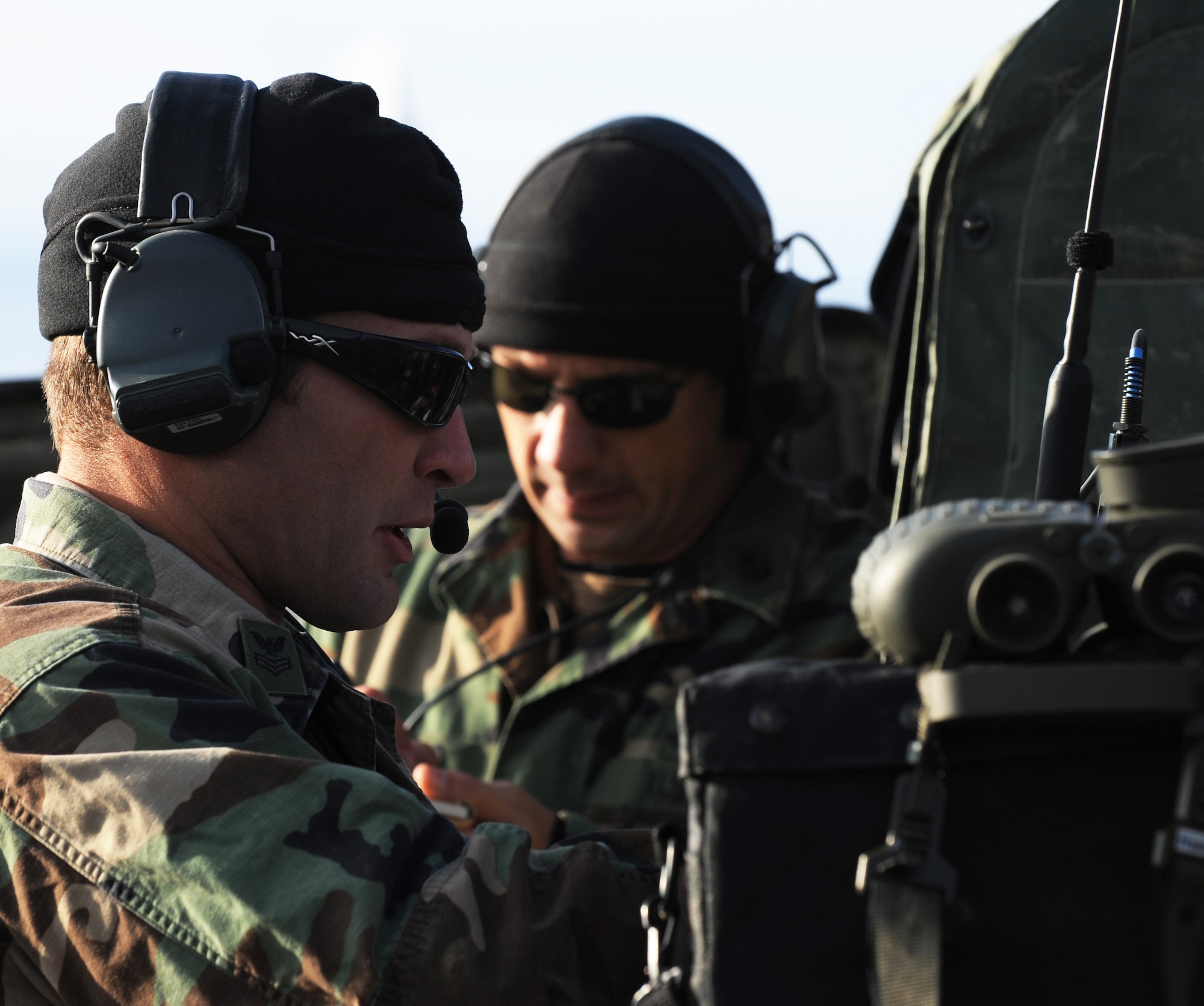 Navy Petty Officer 1st Class Nathan Crossett communicates with an F-16 Fighting Falcon pilot during RED FLAG-Alaska 10-1 Oct. 7, 2009, Eielson Air Force Base, Alaska. The Joint Pacific Alaskan Range Complex provides 67,000 square miles of airspace, more than 30 threat simulators, one conventional bombing range and two tactical bombing ranges containing more than 400 different types of targets. Petty Officer Crossett is a Joint Terminal Air Controller assigned to the Naval Amphibious Base Little Creek, Virginia. (U.S. Air Force photo/Airman 1st Class Laura Goodgame)


