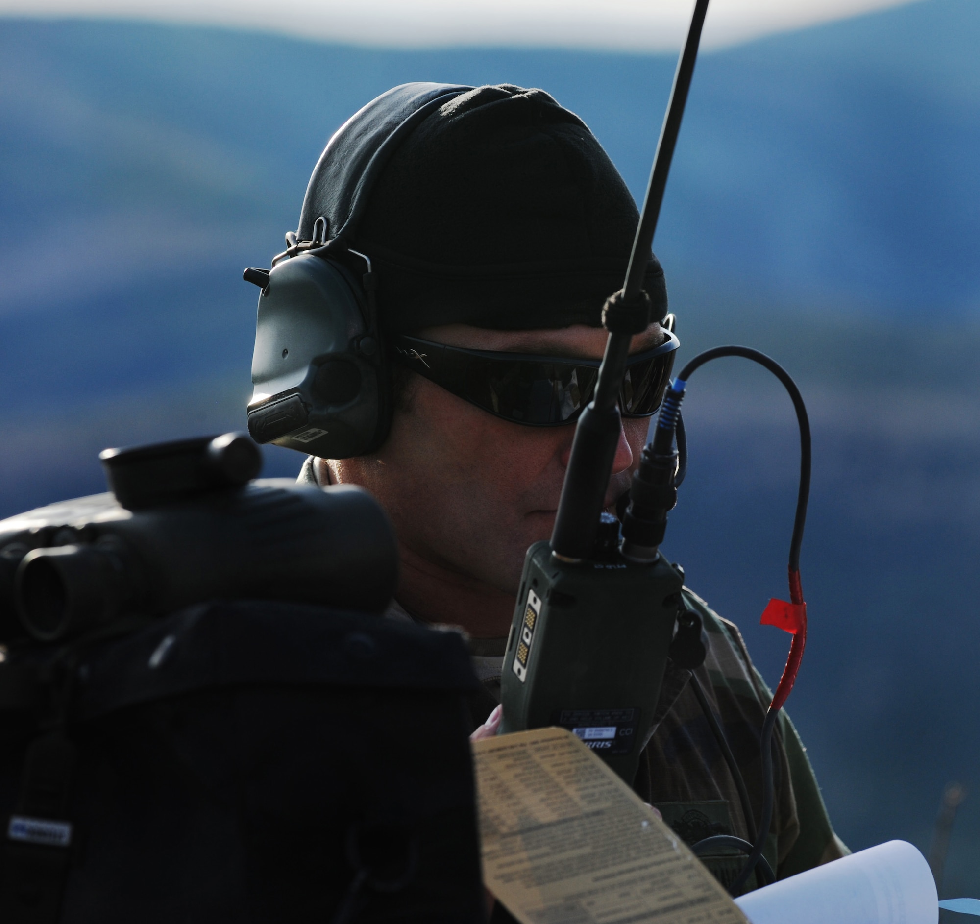 Navy Petty Officer 1st Class Nathan Crossett communicates with an F-16 Fighting Falcon pilot during RED FLAG-Alaska 10-1 Oct. 7, 2009, Eielson Air Force Base, Alaska. The Joint Pacific Alaskan Range Complex provides 67,000 square miles of airspace, more than 30 threat simulators, one conventional bombing range and two tactical bombing ranges containing more than 400 different types of targets. Petty Officer Crossett is a Joint Terminal Air Controller assigned to the Naval Amphibious Base Little Creek, Virginia. (U.S. Air Force photo/Airman 1st Class Laura Goodgame)