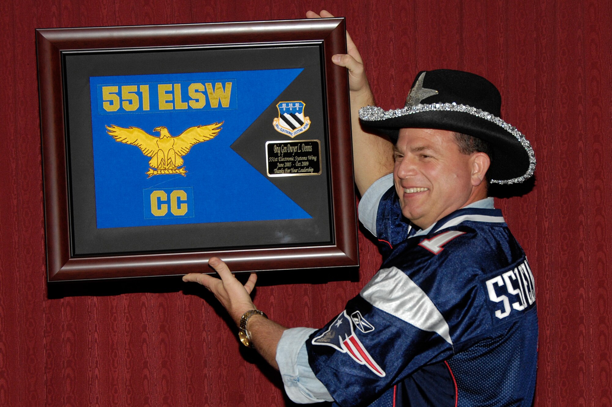 Brig. Gen. Dwyer L. Dennis, 551st Electronic Systems Wing commander, receives a plaque thanking him for his leadership during a farewell dinner Oct. 1. General Dennis will be departing the Electronic Systems Center Oct. 9 for a new assignment at Air Force Materiel Command. (Photo by Linda LaBonte-Britt)
