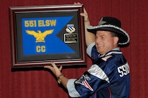 Brig. Gen. Dwyer L. Dennis, 551st Electronic Systems Wing commander, receives a plaque thanking him for his leadership during a farewell dinner Oct. 1. General Dennis will be departing the Electronic Systems Center Oct. 9 for a new assignment at Air Force Materiel Command. (Photo by Linda LaBonte-Britt)
