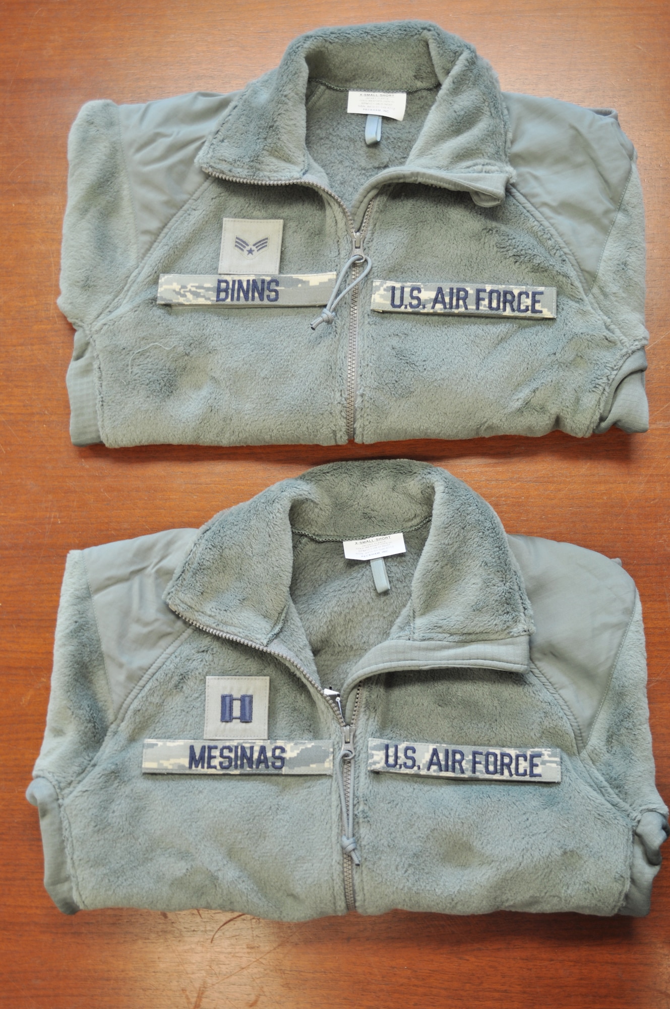 Pictured are sage green fleece outer garments with proper placement of name and rank tapes. Members of the 98th Air Force Virtual Uniform Board released a policy message for wearing the new Air Force sage green fleece as an outer garment for the airman battle uniform. (U.S. Air Force photo) 