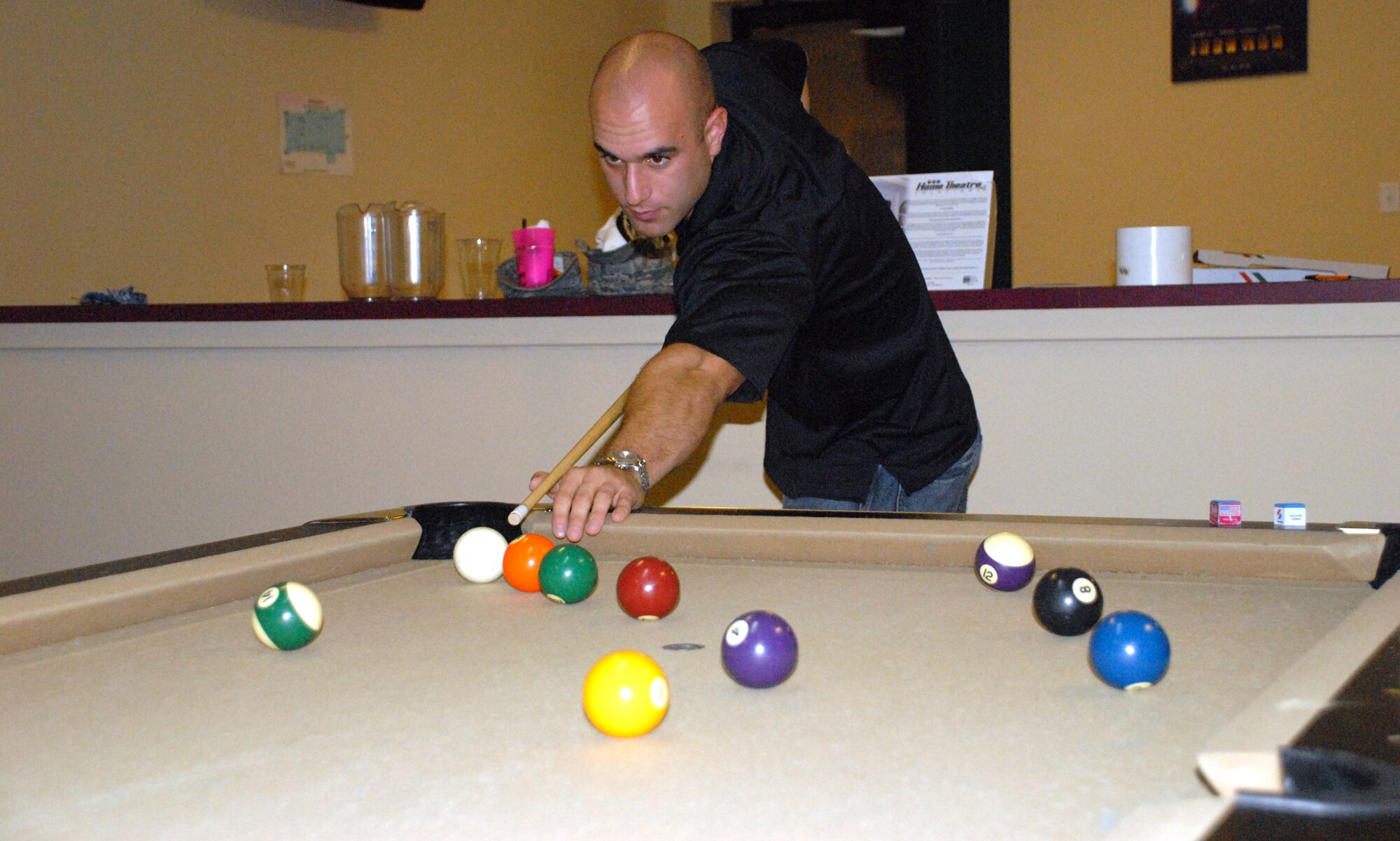 Airman 1st Class Chad Zucchetto, 436th Communications Squadron, plays a game of pool during the Airmen's Social at the Airman's Outpost Oct. 7. The Air Force Sergeant's Association, Dover Airmen Against Drunk Driving and Airmen's Council hosted the event and provided free food, drinks and door prizes. (U.S. Air Force photo/ Airman 1st Class Shen-Chia Chu)