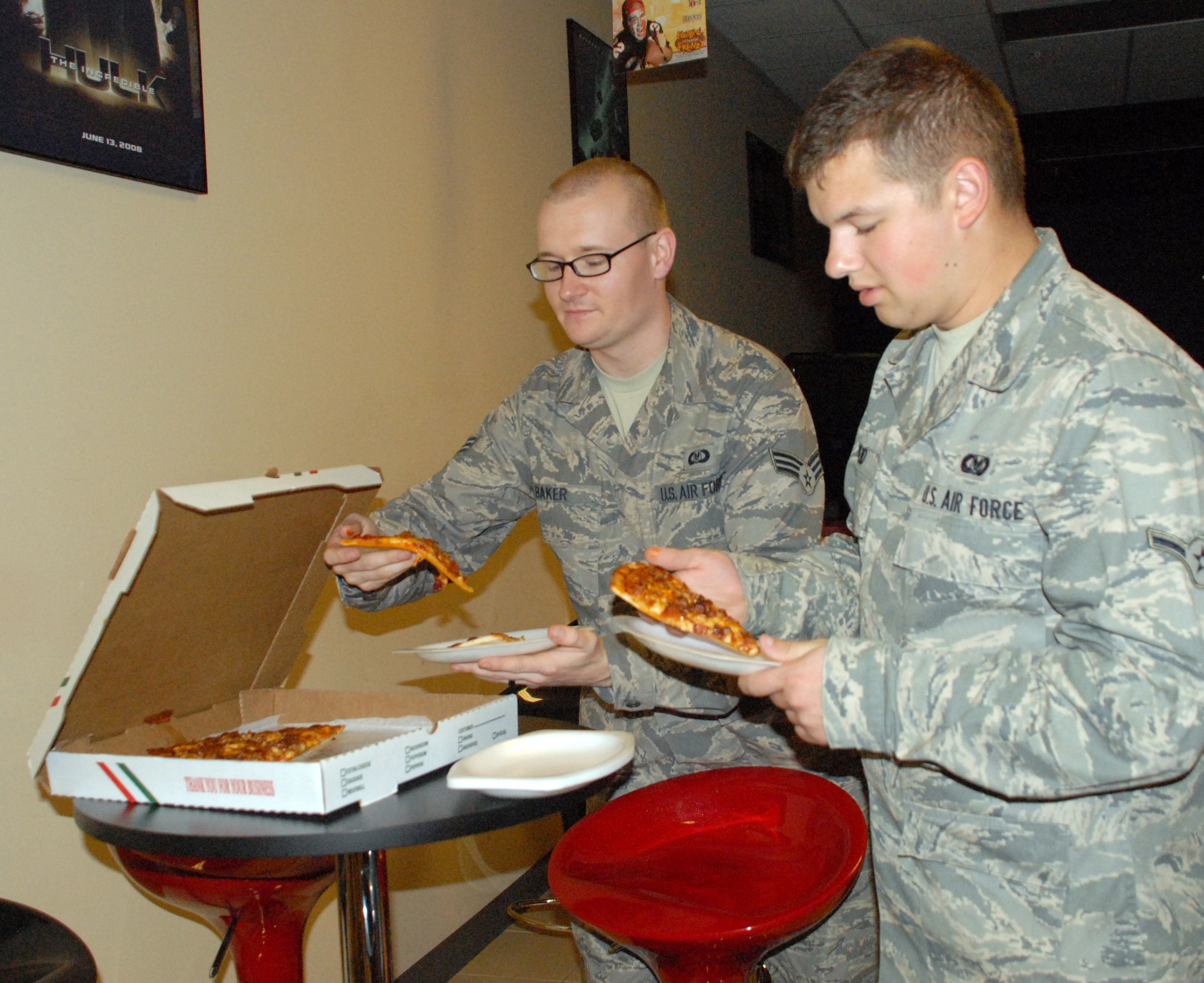 Senior Airman Jerry Baker, 436th Operations Support Squadron, and Airman Nathaniel Reid, 436th Operations Group, grab a slice of pizza during the Airmen's Social at the Airman's Outpost Oct. 7. The Air Force Sergeant's Association, Dover Airmen Against Drunk Driving and Airmen's Council hosted the event and provided free food, drinks and door prizes. (U.S. Air Force photo/ Airman 1st Class Shen-Chia Chu)
