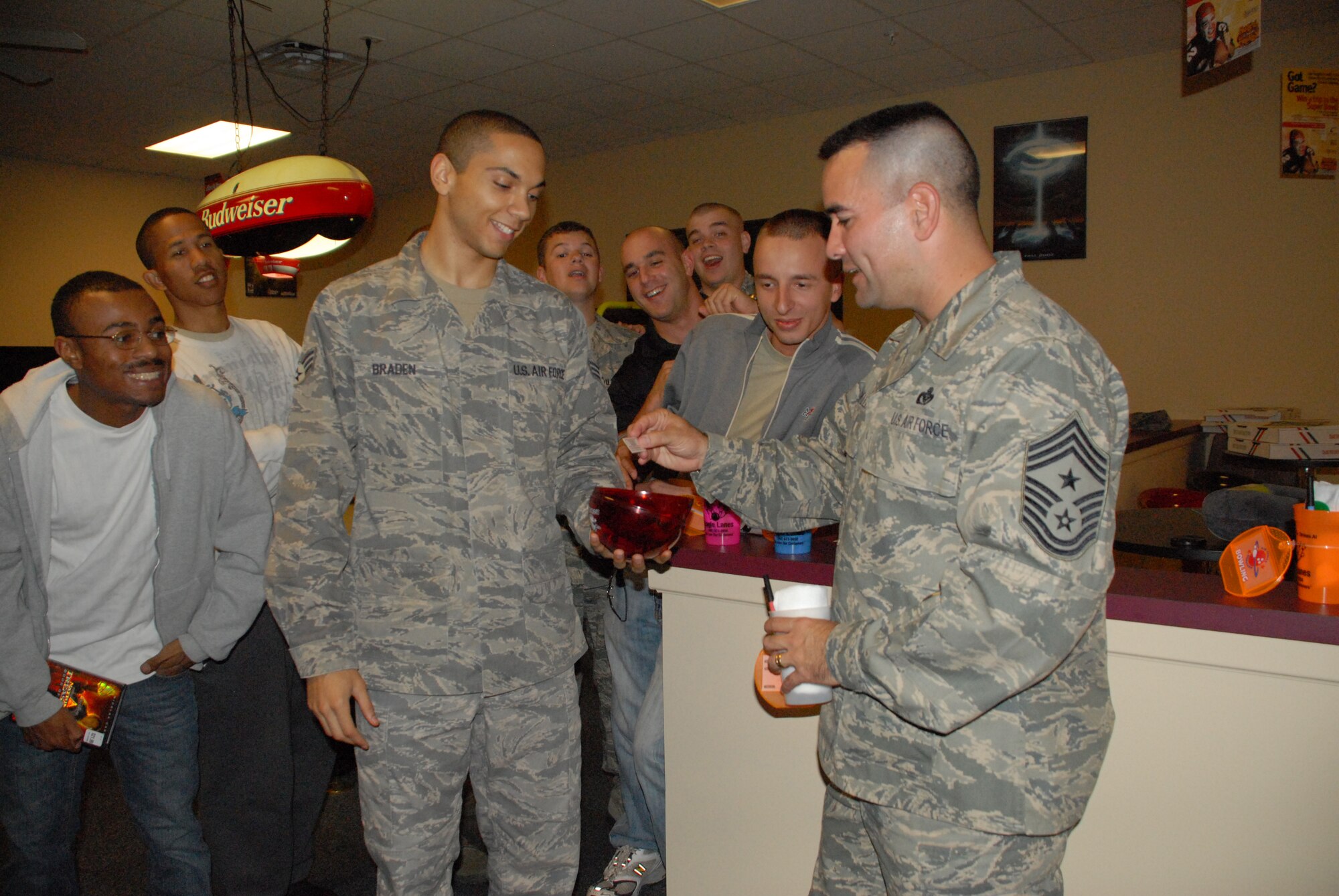 (Right) Chief Master Sgt. John Evalle, 436th Airlift Wing command chief, draws a raffle ticket to award a door prize at the Airmen's Social Oct. 7. The Air Force Sergeant's Association, Dover Airmen Against Drunk Driving and Airmen's Council hosted the event and provided free food, drinks and door prizes. (U.S. Air Force photo/ Airman 1st Class Shen-Chia Chu)