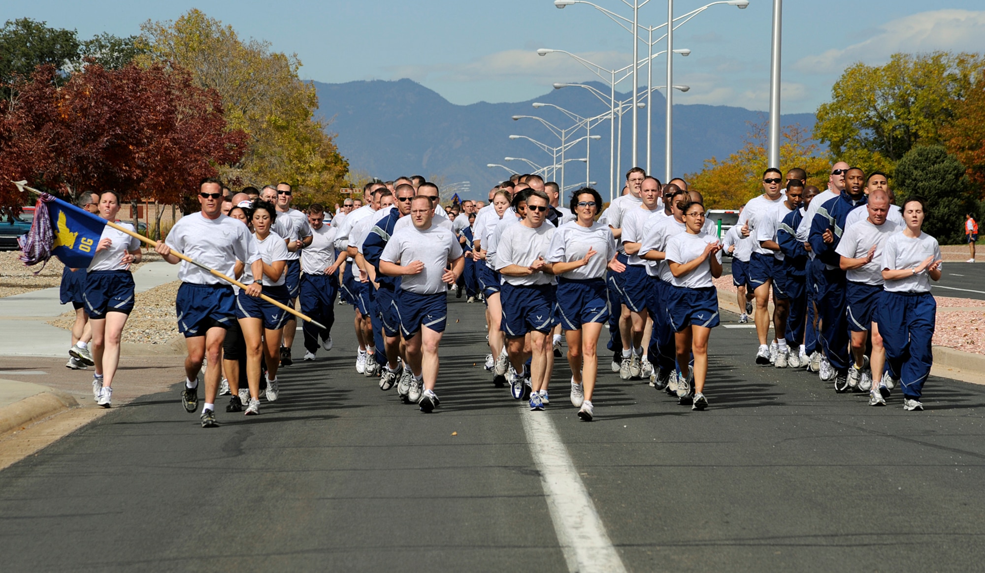 21st Operations Group Airmen run in formation on Ent Avenue during the Wingman Day 1.5 mile run Oct 7. The 21st Space Wing observed Wingman Day with a variety of activities including briefings on alcohol awareness, financial management, suicide awareness and a Warfit session. 21st SW Airmen and civilians also participated in team building or “break- out sessions” following the run.   (Air Force photo by Rob Bussard)



