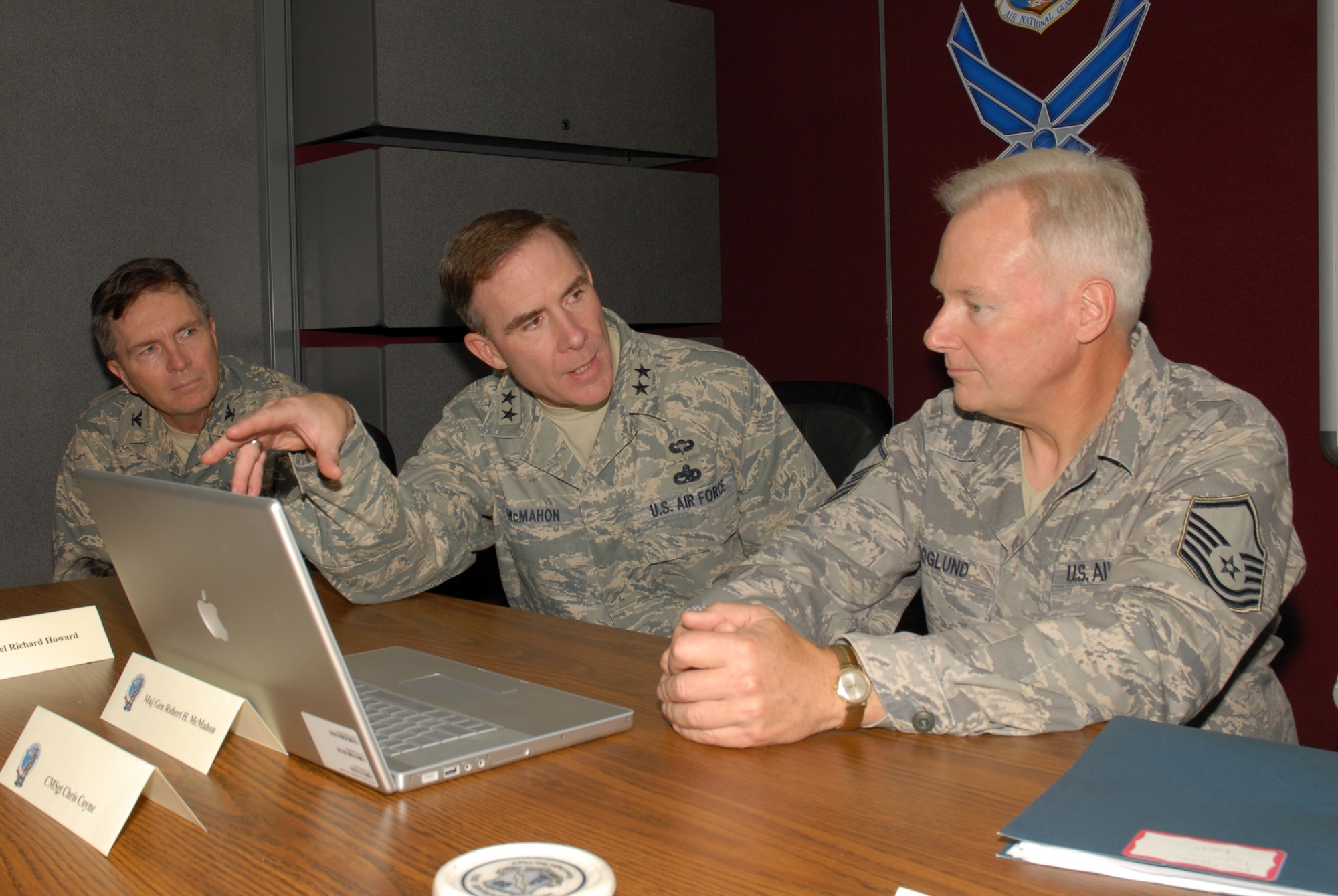 McGHEE TYSON AIR NATIONAL GUARD BASE, Tenn. -- Maj. Gen. Robert H. McMahon, center, the Air Force Director of Logistics, Deputy Chief of Staff for Logistics, Installations and Mission Support at Headquarters U.S. Air Force, reviews graphic design elements in the Nuclear Weapons Related Materiel (NWRM) Fundamentals course the Transformative Education branch is producing for the U.S. Air Force with Master Sgt. Kurt Skoglund, graphics and multimedia coordinator, right, and Col Richard B. Howard, commander, left, at The I.G. Brown Air National Guard Training and Education Center here, Oct. 8, 2009.  McMahon was at the center to videotape an introductory segment for the interactive computer based training course. (U.S. Air Force photo by Master Sgt. Mavi Smith)