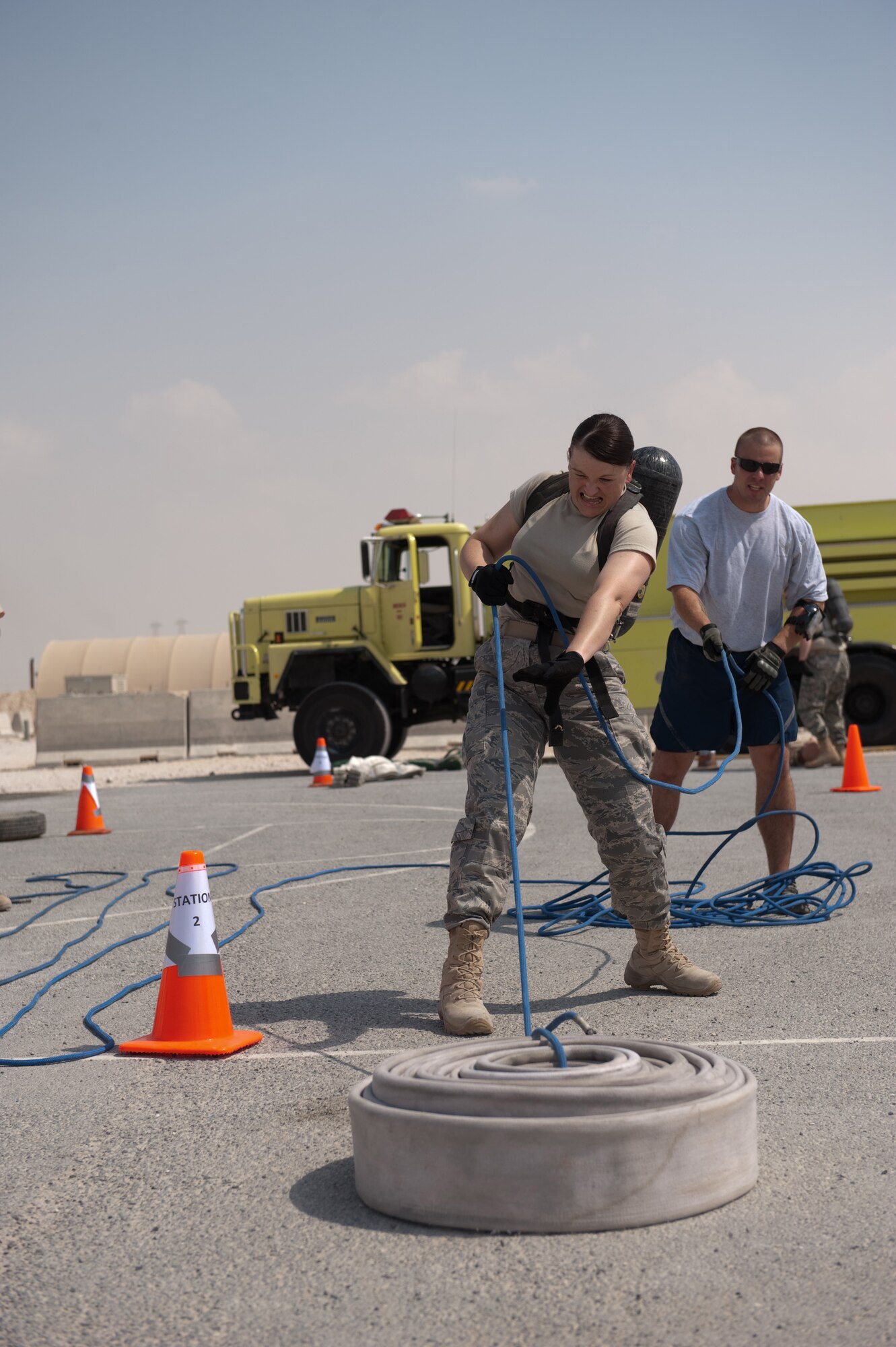 Maj. Michelle Griffith, 379th Air Expeditionary Wing comptroller, competes in the hose pull event during a fire muster competition, Oct. 11, 2009, in Southwest Asia. The 379th Civil Engineer squadron Fire Department concluded fire safety week here with a muster that simulated multiple events and exercises firefighters perform on a regular basis. (U.S. Air Force photo/Staff Sgt. Robert Barney) 
