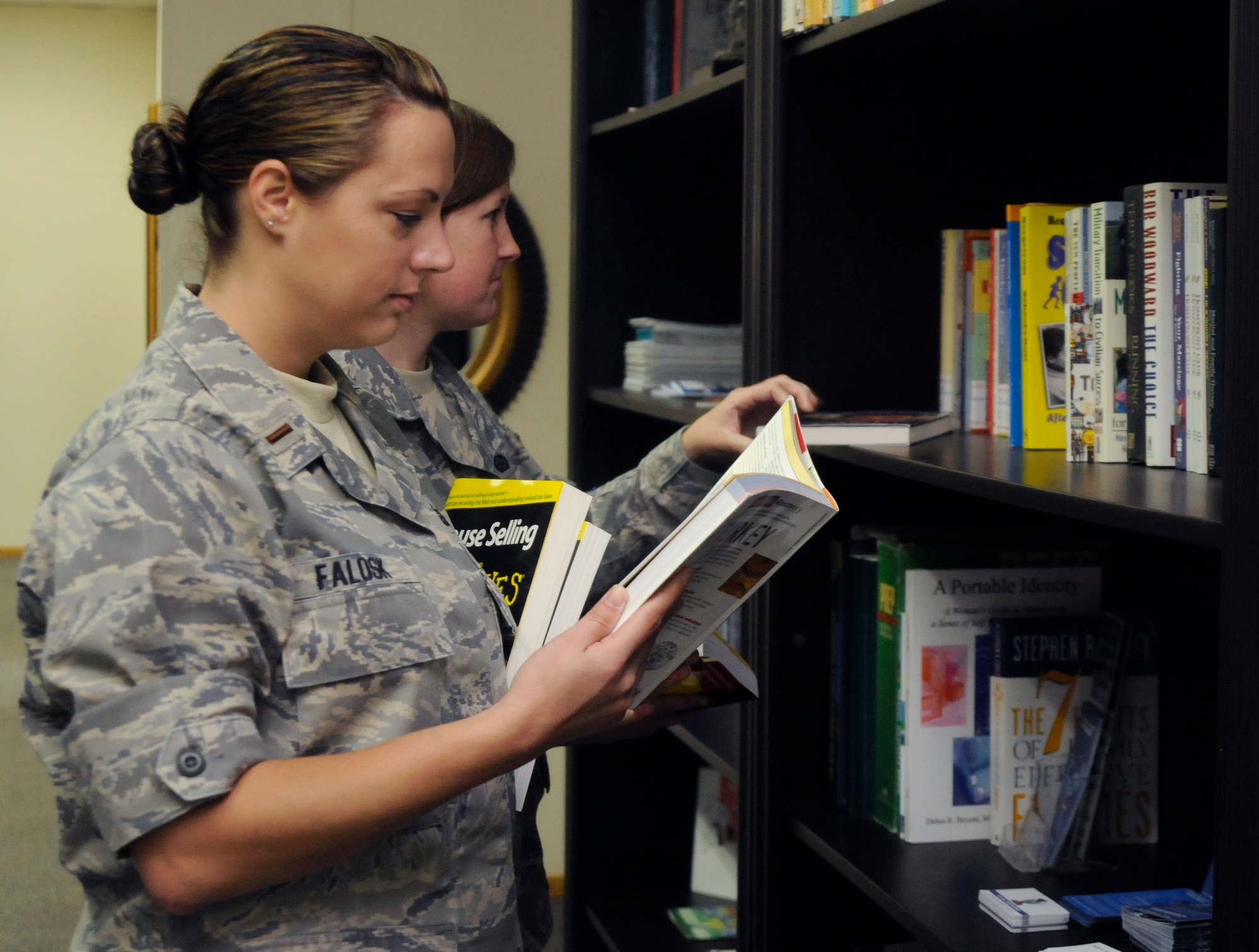 2nd Lt. Bridgette Falosk, 39th Force Support Squadron, studies books the Airman and Family Readiness Center has to offer for free and for checkout, during the Open House, Oct. 9, 2009, at Incirlik Air Base, Turkey. The AFRC has much to offer for the base populace from financial and deployment information, assistance with job searching and resumes and a WiFi hotspot for those without internet. (U.S. Air Force photo/Airman 1st Class Amber Ashcraft)