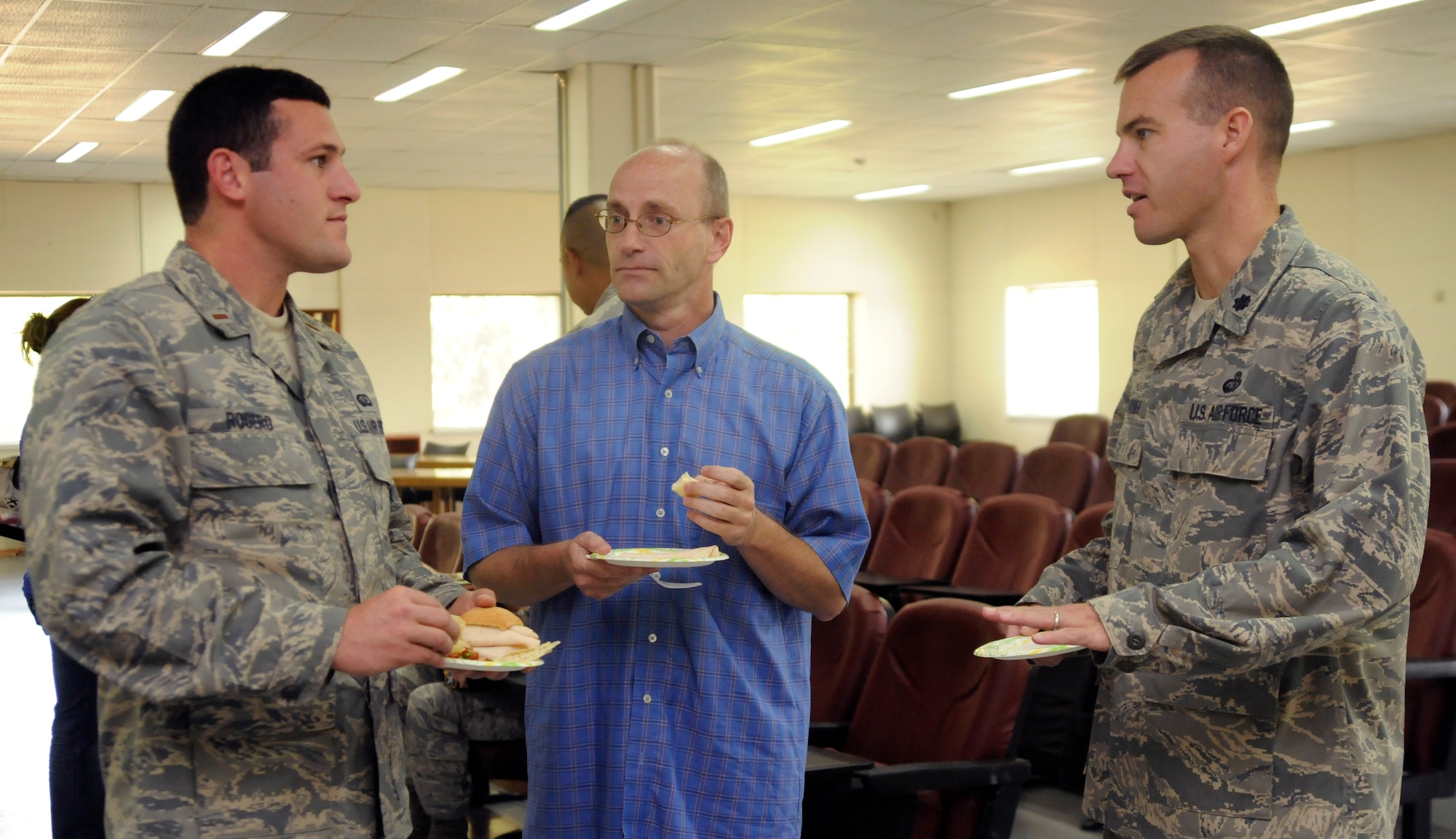 (Left to Right) 2nd Lt. Matthew Rogero, Steve Sha, both from the 39th Force Support Squadron, and Lt. Col. James Turner, 39th FSS commander, converse about the Airman and Family Readiness Center’s new facility and training room during its open house, Oct. 9, 2009, at Incirlik Air Base, Turkey. The training room houses the newcomer’s briefing, the transition assistance program and other briefings open to the base. (U.S. Air Force photo/Airman 1st Class Amber Ashcraft)