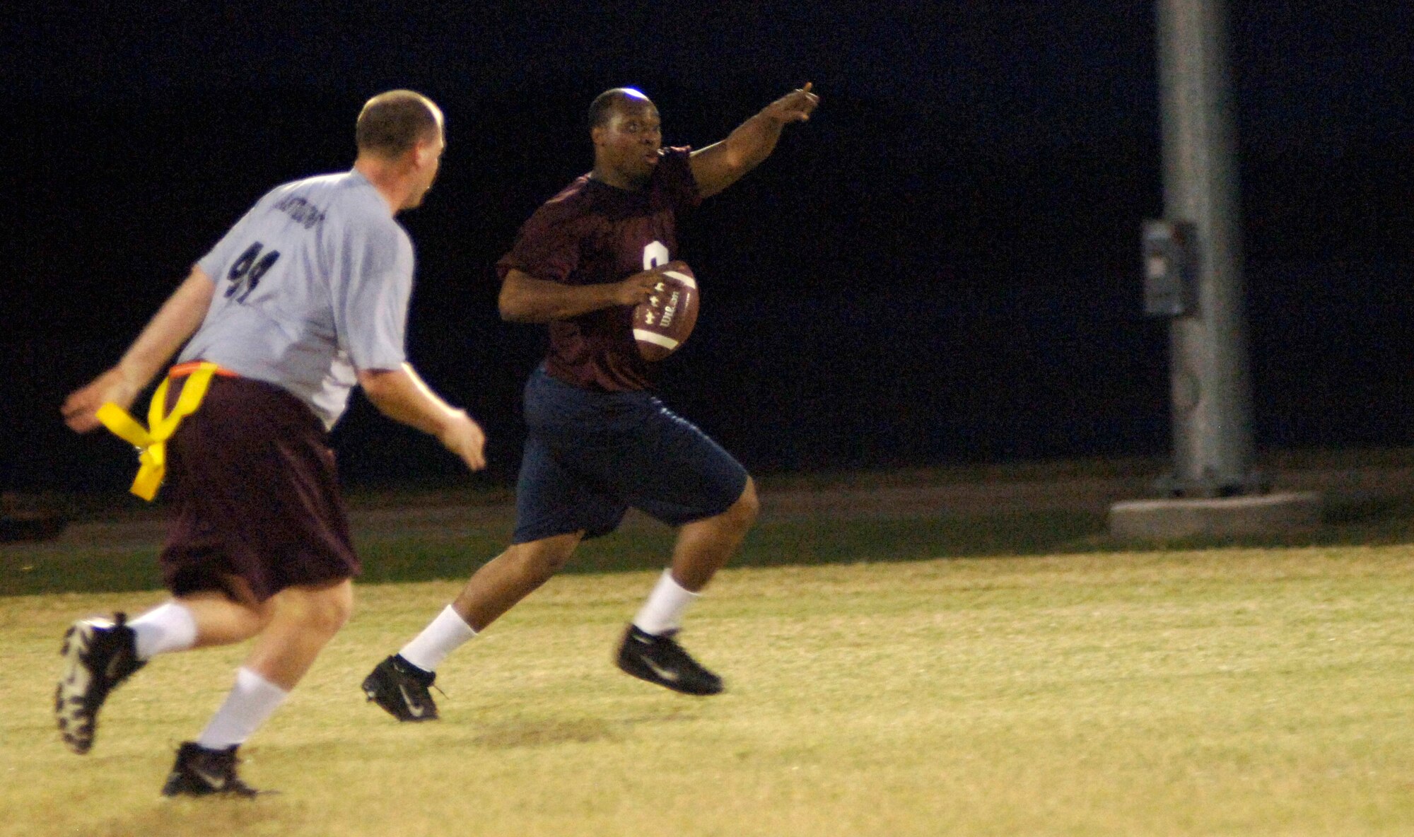 LANGLEY AIR FORCE BASE, Va. -- Air Combat Command/A8 quarterback Etienne Menard signals to receivers downfield during a flag football game against the 497th Intelligence, Suveillance, and Reconnaissance team here Oct. 8. The ACC/A8 team won the game, 25-6. (U.S. Air Force photo/Airman 1st Class Jason J. Brown)