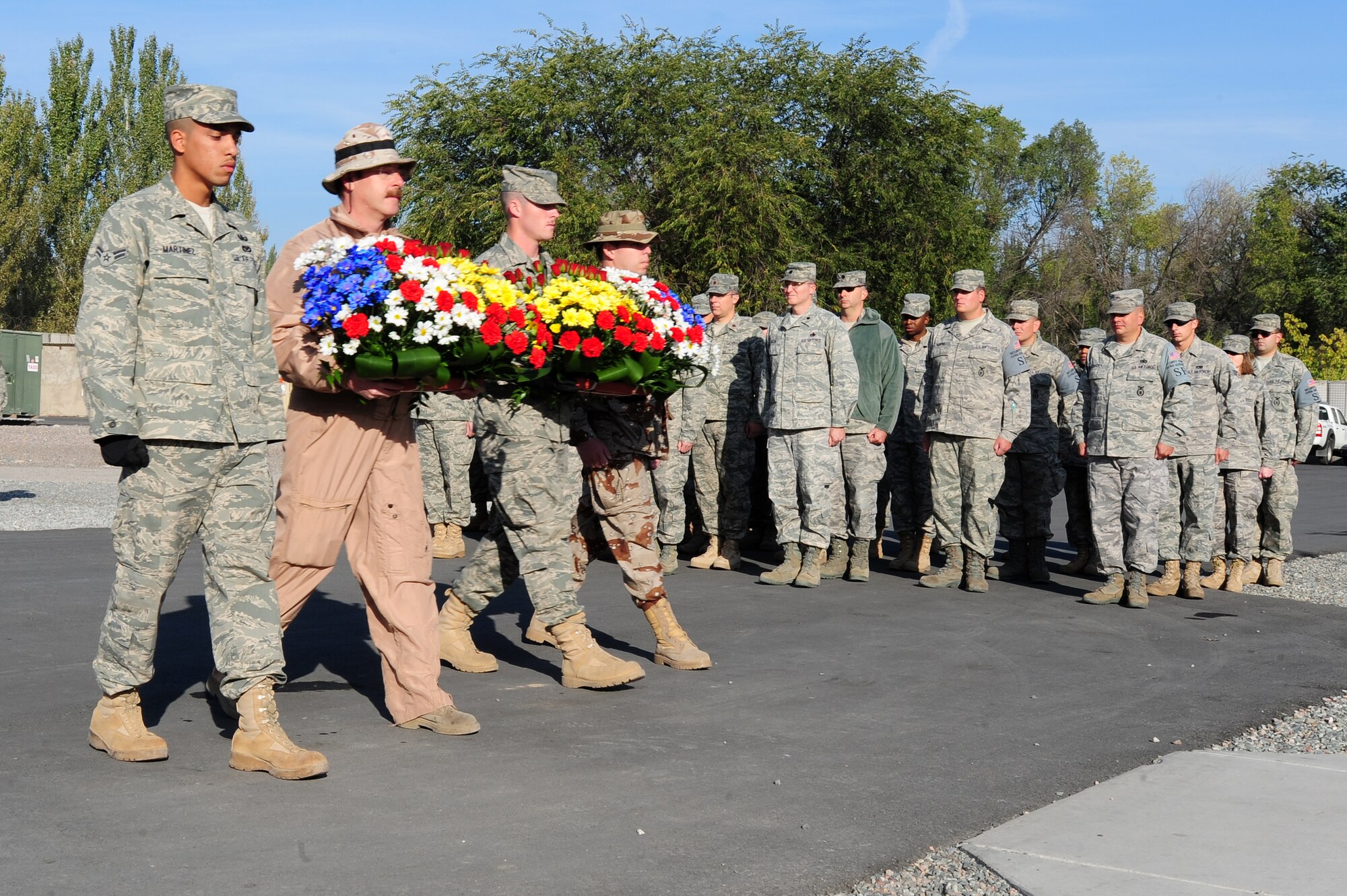 TRANSIT CENTER AT MANAS, Kyrgyzstan -- Air Force service members of the U.S. and Spain proceed to 9/11 and Spanish memorials to place flowers in remembrance of those who have made the ultimate sacrifice in support of operation ENDURING FREEDOM on Oct. 13, 2009. (U.S. Air Force photo/Senior Airman Steele C. G. Britton)