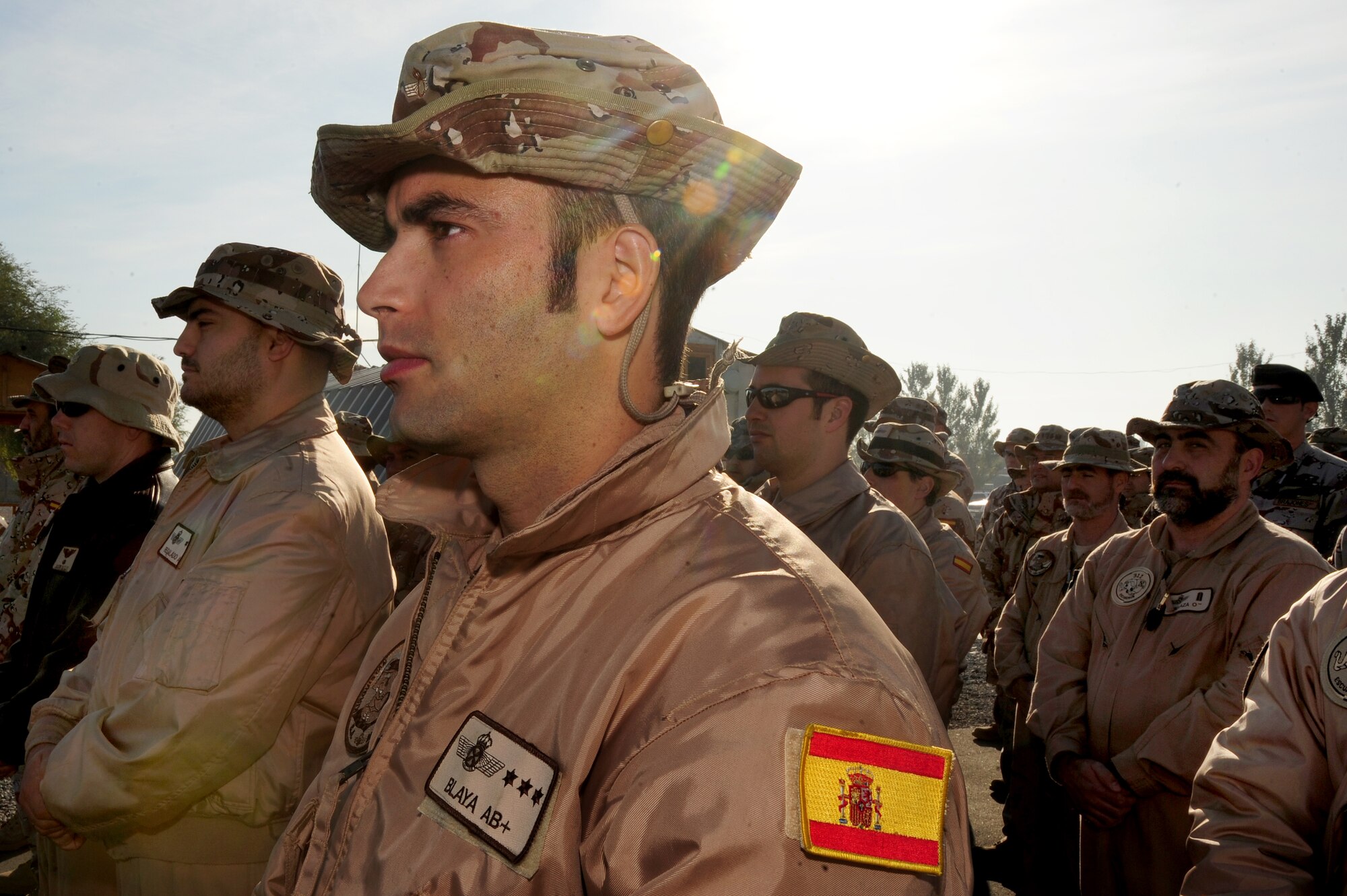 TRANSIT CENTER AT MANAS, Kyrgyzstan -- Spanish Air Force service members stand in formation during a remembrance ceremony for fallen comrades since the start of operation ENDURING FREEDOM. The Spanish Mizar Detachment marked the end of a tour at the Transit Center by conducting a lowering of the Spanish flag signifying a halt in service at Manas. (U.S. Air Force photo/Senior Airman Steele C. G. Britton)