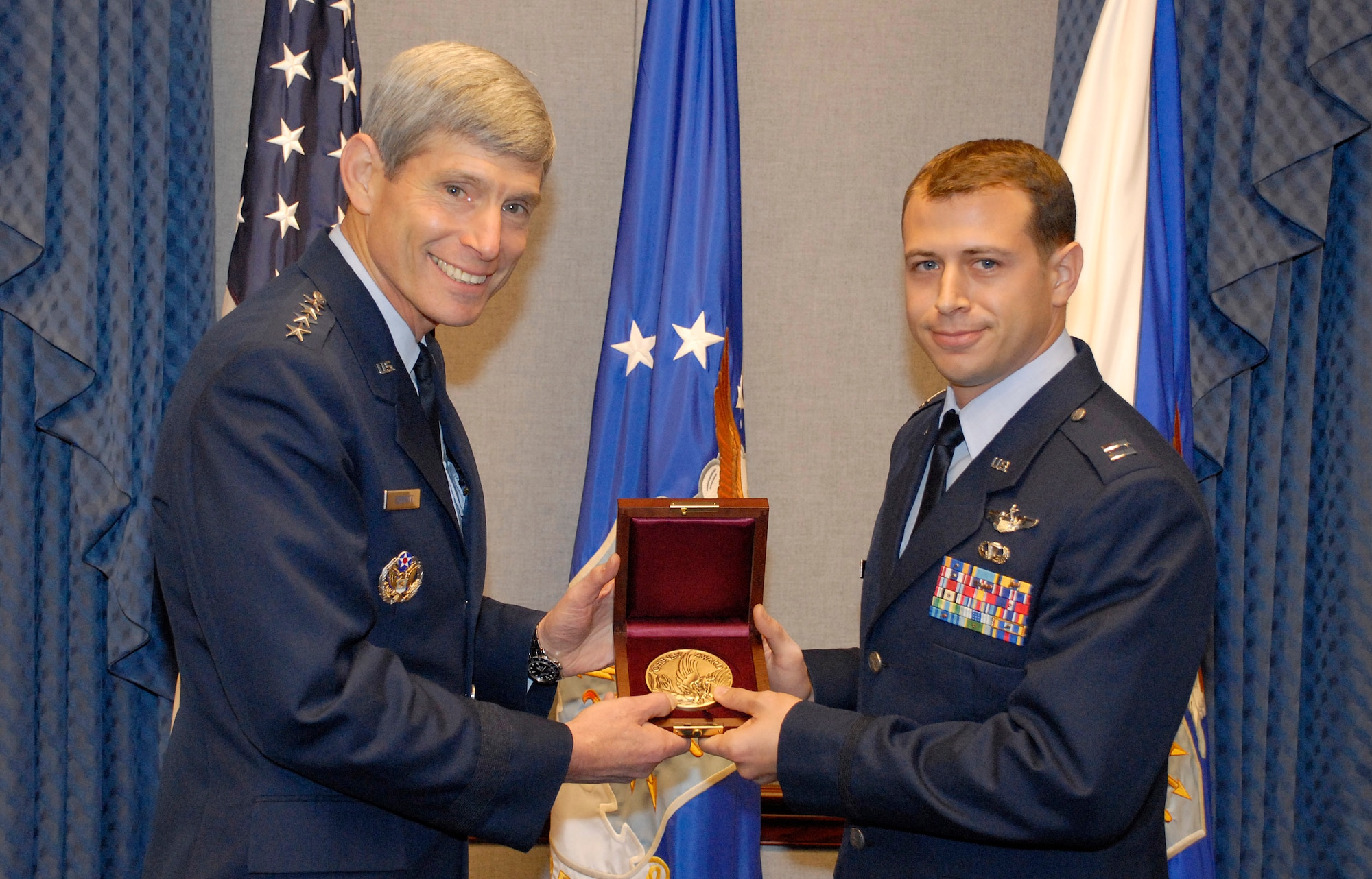 Air Force Chief of Staff Gen. Norton Schwartz presents Capt. Daniel Santoro with the Cheney Award Oct. 8, 2009 at the Pentagon. Captain Santoro's leadership and foresight led his squadron to successfully complete 29 missions, delivering 95 passengers and 211 tons of humanitarian aid to the war-torn country of Georgia, following an August 2008 Russian invasion. Capt. Santoro is a C-130E Hercules instructor pilot and the chief of tactics assigned to the 37th Airlift Squadron at Ramstein Air Base, Germany. (U.S. Air Force photo/Master Sgt. Stan Parker)
