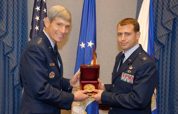 Air Force Chief of Staff Gen. Norton Schwartz presents Capt. Daniel Santoro with the Cheney Award Oct. 8, 2009 at the Pentagon. Captain Santoro's leadership and foresight led his squadron to successfully complete 29 missions, delivering 95 passengers and 211 tons of humanitarian aid to the war-torn country of Georgia, following an August 2008 Russian invasion. Capt. Santoro is a C-130E Hercules instructor pilot and the chief of tactics assigned to the 37th Airlift Squadron at Ramstein Air Base, Germany. (U.S. Air Force photo/Master Sgt. Stan Parker)
