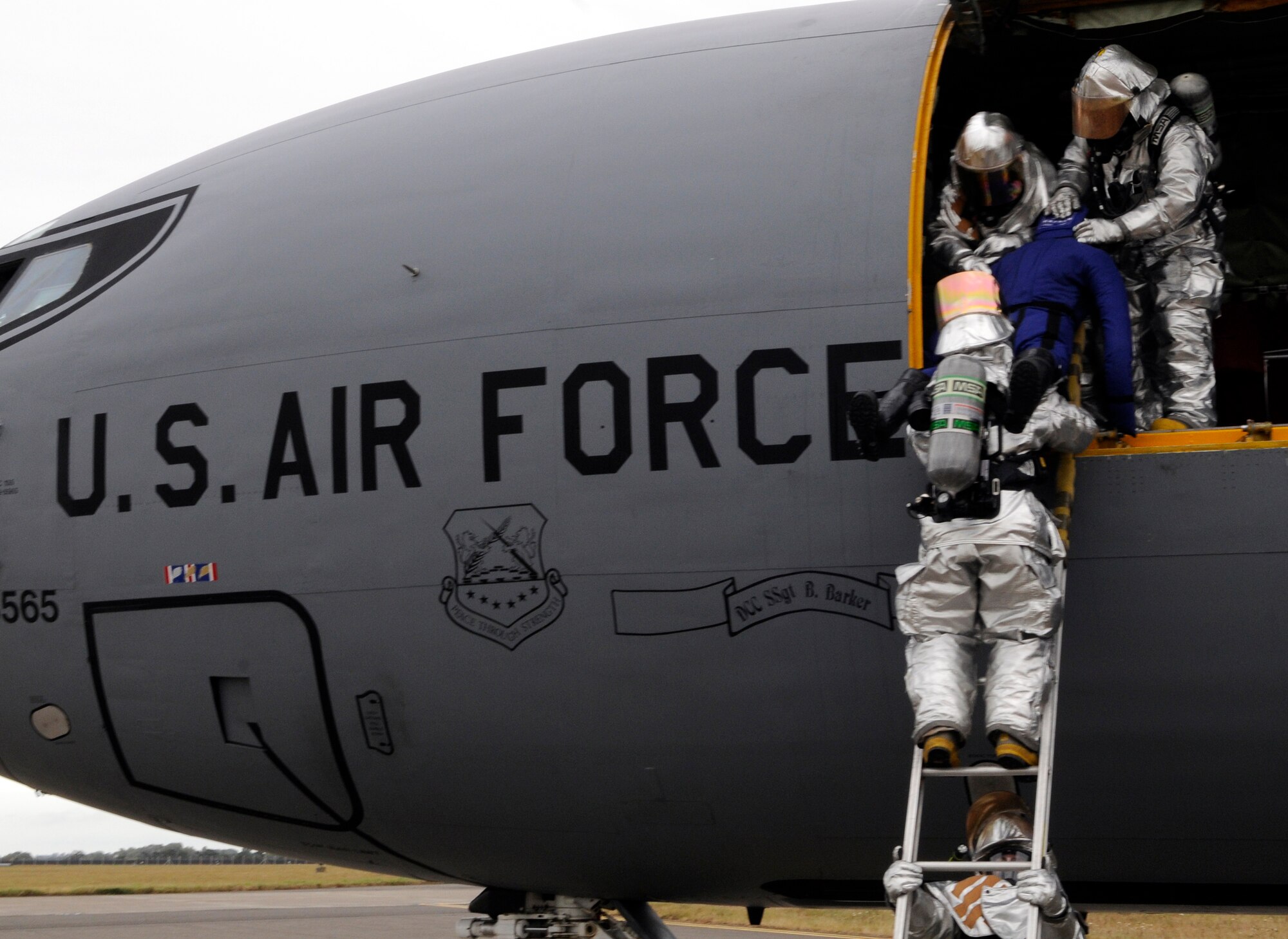 RAF MILDENHALL, England -- 100th Civil Engineer Squadron firefighters carefully extract a simulated aircrew member during the egress portion of the Operational Readiness Inspection Oct. 12.  Saving aircrew in a wartime environment is one of many wartime scenarios being tested during the inspection.  (U.S. Air Force photo/Staff Sgt. Christopher L. Ingersoll)
