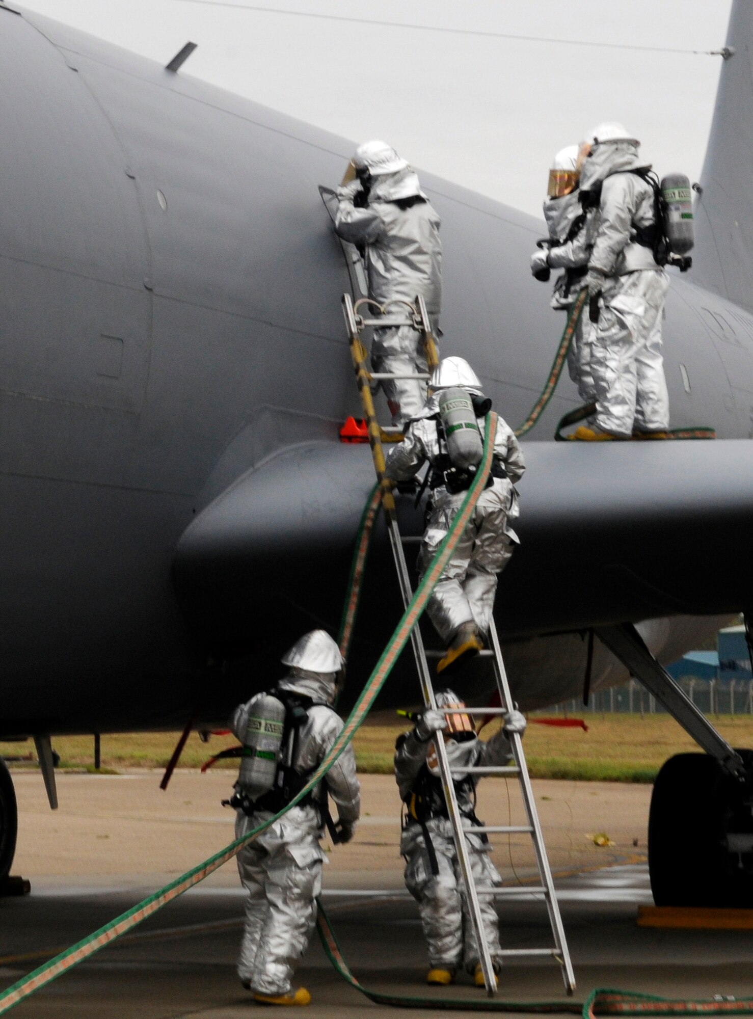 RAF MILDENHALL, England -- 100th Civil Engineer Squadron firefighters enter a KC-135 Stratotanker to extract the crew during a simulated egress as part of the Operational Readiness Inspection Oct. 12.  The egress marks the midpoint of a two-week inspection testing several aspects of wartime scenarios.  (U.S. Air Force photo/Staff Sgt. Christopher L. Ingersoll)
