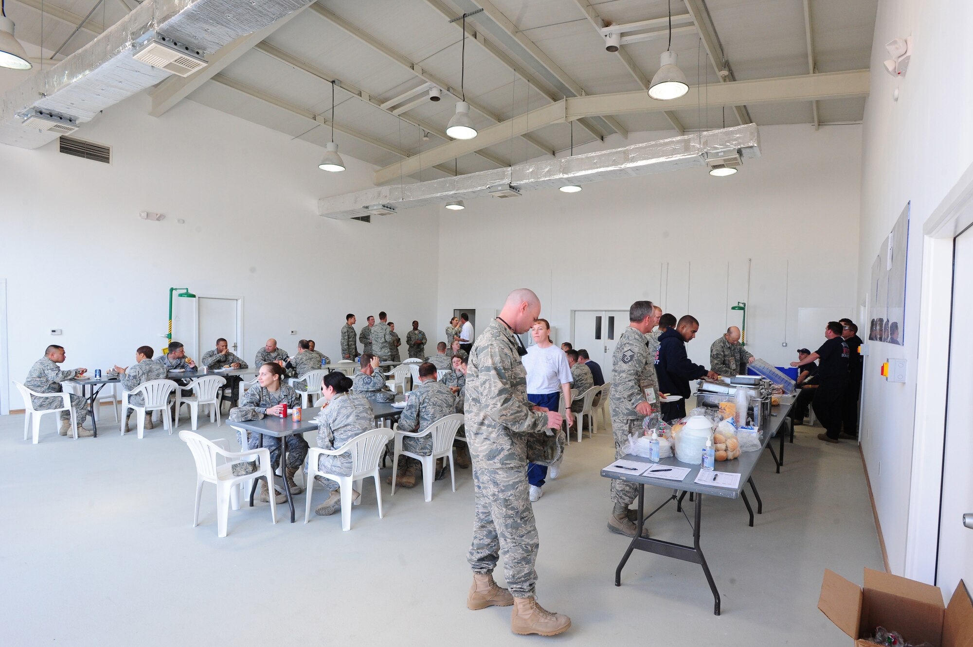 TRANSIT CENTER AT MANAS, Kyrgyzstan -- The newly-built fire station's truck bay is open for those at Manas to enjoy lunch and a view of the station's amenities at the Transit Center.  The 376th ECES Fire & Emergency Services Team, of Sallyport Global Services, spent a week sharing their knowledge with military members and contractors at the Transit Center to include fire extinguisher training for over 150 personnel, an open house of their new station, and fire fighting challenge competitions. (U.S. Air Force photo/Senior Airman Steele C. G. Britton)