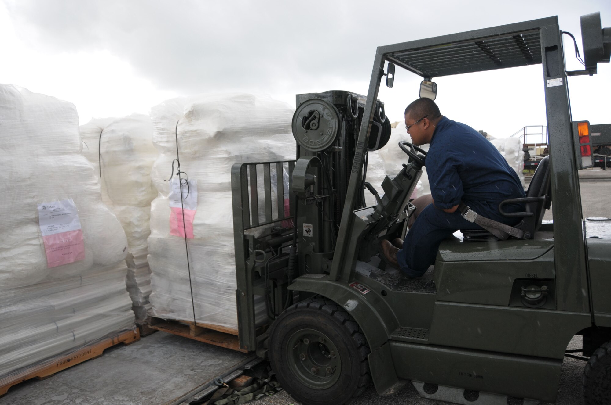 Timothy Lubasan, a warehouse specialist from DZSP 21, builds a pallet full of FEMA tents Oct. 9 at Andersen Air Force Base, Guam, for delivery to American Samoa after the area was struck by an earthquake and resulting tsunami. A total of 13 pallets containing 800 tents will be flown by an Air Force C-17 Globemaster III in support of FEMA's humanitarian aid mission. (U.S. Air Force photo by Master Sgt. Carrie Hinson) 