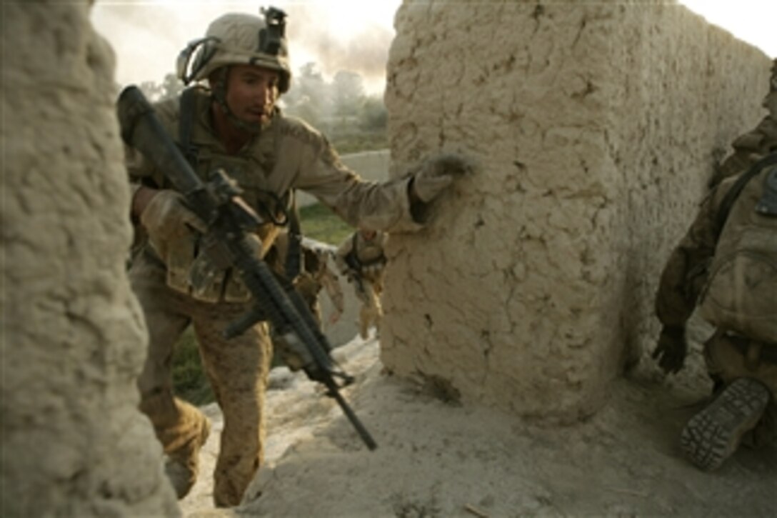 U.S. Marine Corps Lance Cpl. Joe Helmick, with 2nd Battalion, 8th Marine Regiment, runs for cover during an attack at Patrol Base Bracha in the Garmsir district of Helmand province, Afghanistan, on Oct. 9, 2009.  The Marines are deployed with Regimental Combat Team 3, whose mission is to conduct counterinsurgency operations in partnership with Afghan security forces in southern Afghanistan.  