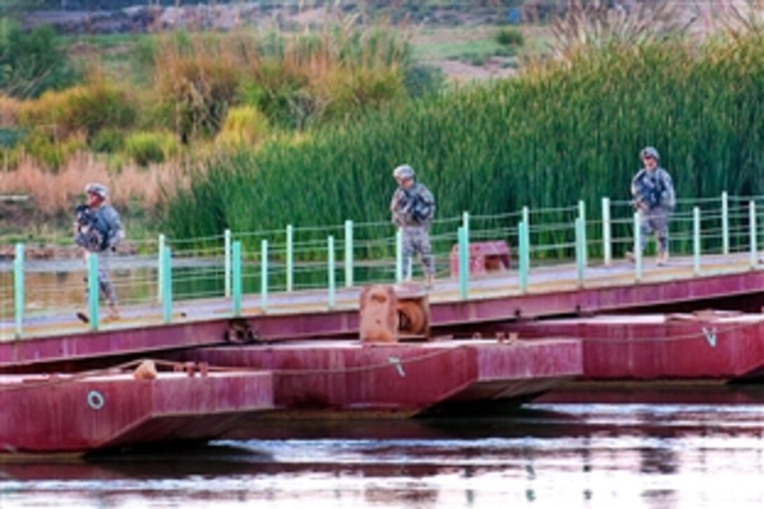 U.S. Army soldiers return from a patrol across the Euphrates River while assisting Iraqi police, who are providing security for a nearby bridge project north of Al Taqaddum, Iraq, Oct. 5, 2009. The soldiers are assigned to the 82nd Airborne Division's Company C, 1st Battalion, 504th Parachute Infantry Regiment, 1st Brigade Combat Team. The airborne unit is the first organic advise-and-assist brigade assigned the mission of security-force assistance.