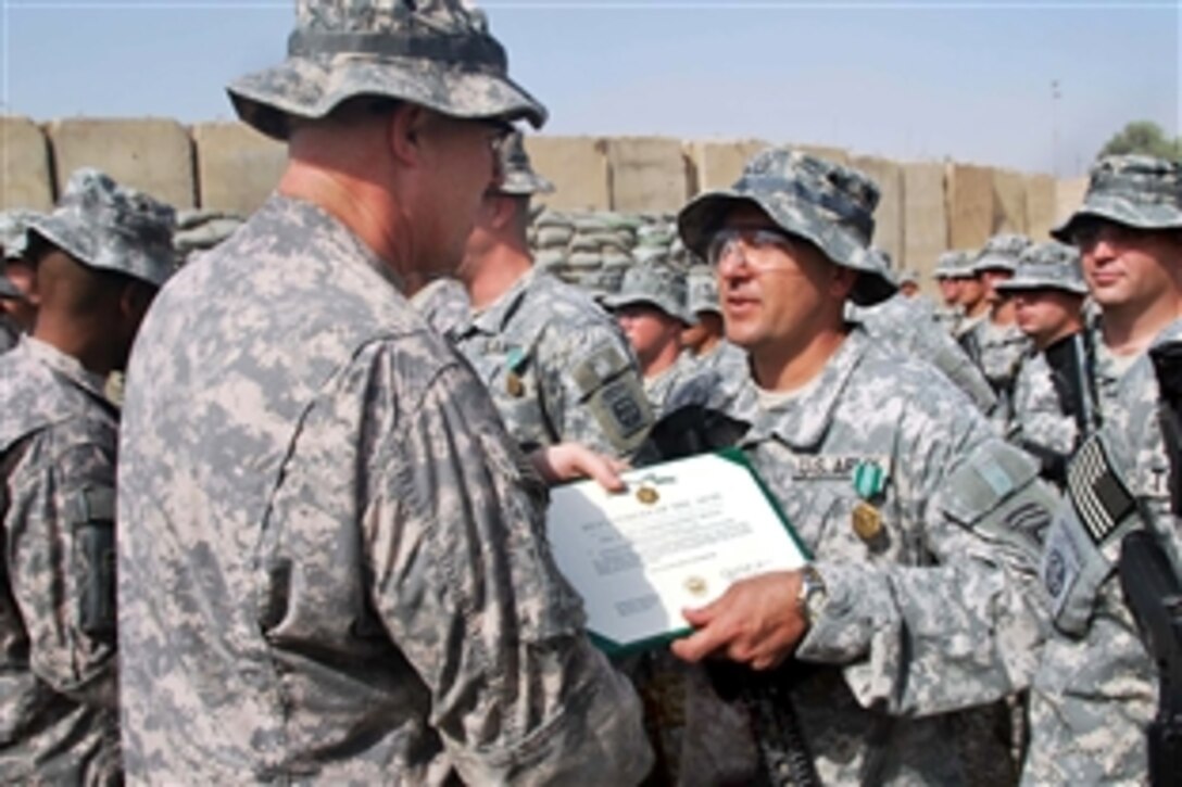 U.S. Army Col. Timothy McGuire, left, congratulates paratroopers during an award ceremony at the end of their tour on Joint Security Station Zafaraniya, Iraq, Oct. 11, 2009. McGuire is commander of the 82nd Airborne Division's 3rd Brigade Combat Team. The paratroopers are assigned to the 82nd Airborne Division's 1st Battalion, 319th Airborne Field Artillery Regiment, 3rd Brigade Combat Team.