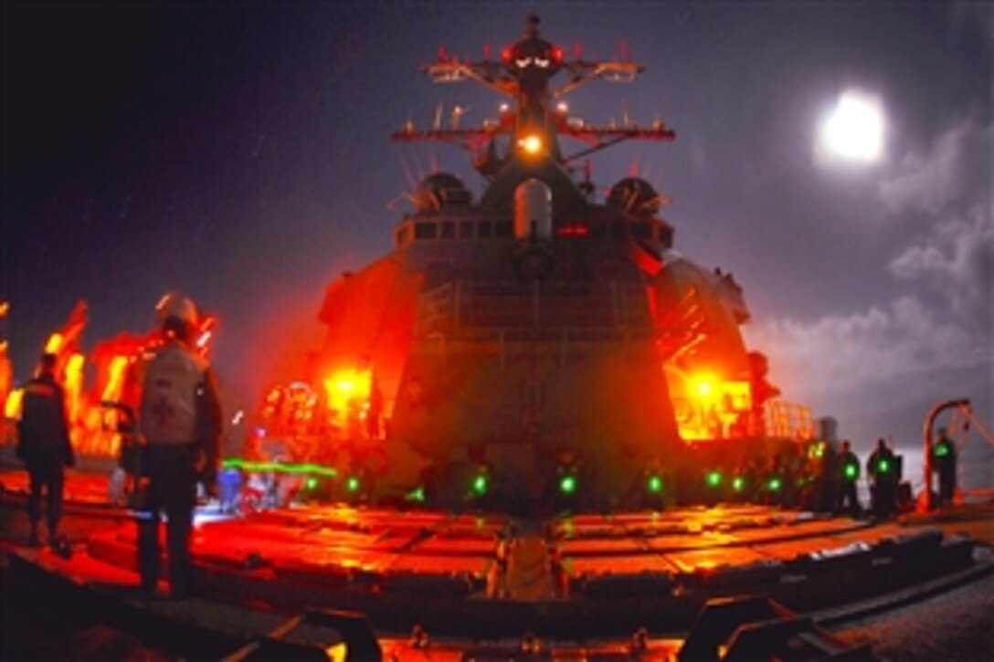 Moonlight illuminates the forecastle aboard the guided missile destroyer the USS Cole as sailors conduct an early morning replenishment-at-sea in the Atlantic Ocean, Oct. 10, 2009. The Cole is participating in Exercise Joint Warrior, a multinational exercise led by the United Kingdom to improve interoperability among allied navies and to prepare for a role in combined operations during upcoming deployments.