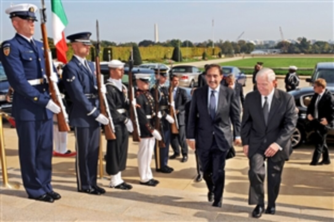 U.S. Defense Secretary Robert M. Gates, right,  escorts Italian Defense Minister Ignazio La Russa through an honor cordon representing all five services into the Pentagon, Oct. 13, 2009, for bilateral security talks.