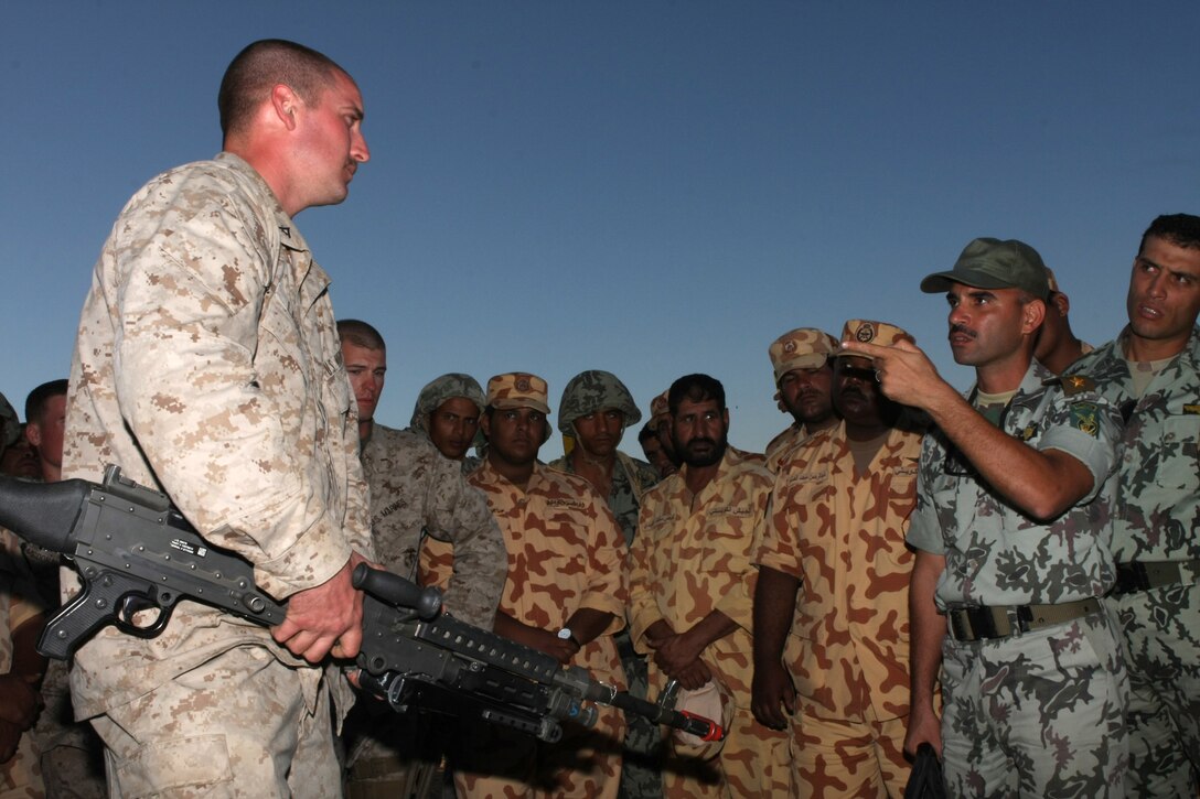 Lance Cpl. Matt Lauer, a machine gunner with Lima Company, Battalion Landing Team, 3rd Battalion, 2nd Marine Regiment, 22nd Marine Expeditionary Unit and native of Scaggsville, Md., speaks to a Middle Eastern interpreter about the M-240B medium machine gun during Exercise Bright Star 2009 in Egypt, Oct. 13, 2009. The multinational exercise is designed to improve readiness, interoperability, and strengthen the military and professional relationships among U.S., Egyptian and participating forces. Bright Star is conducted by U.S. Central Command and held every two years. Elements of the 22nd MEU are currently are participating in the multi-national exercise while serving as the theater reserve force for U.S. Central Command.::r::::n::(Official Marine Corps Photo by Cpl. Justin M. Martinez)::r::::n::